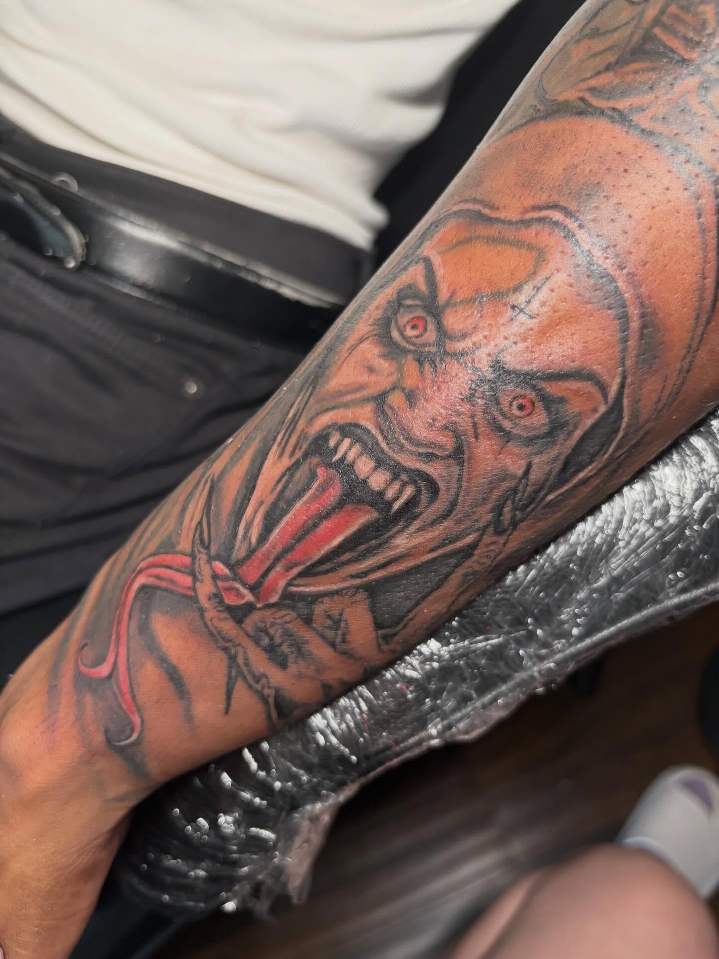 Clown realism tattoo on the forearm by K.L Tattoo Uptown