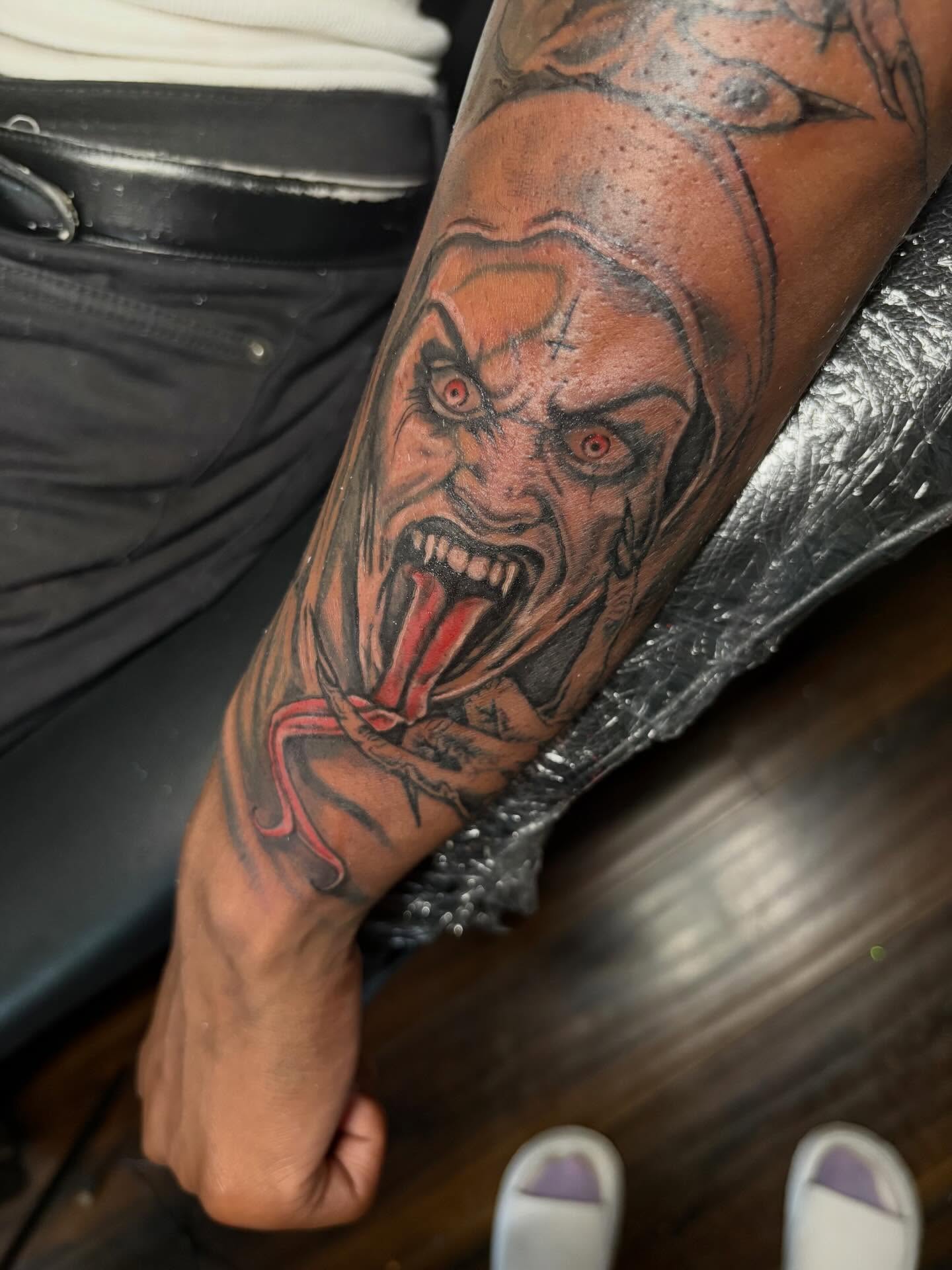 Demon face dark realism tattoo on the forearm by K.L Tattoo Uptown