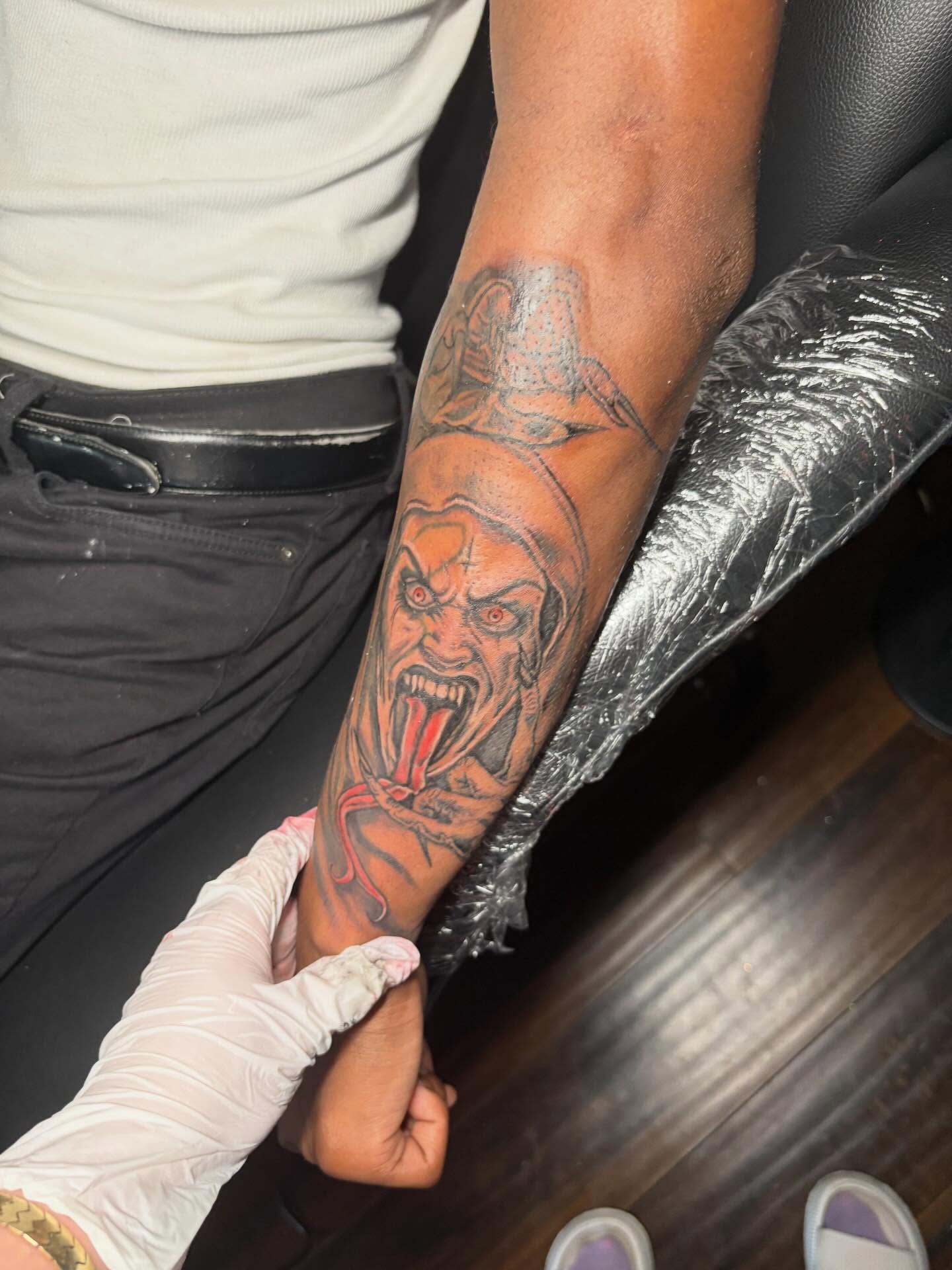Demon head dark realism tattoo on the forearm by K.L Tattoo Uptown