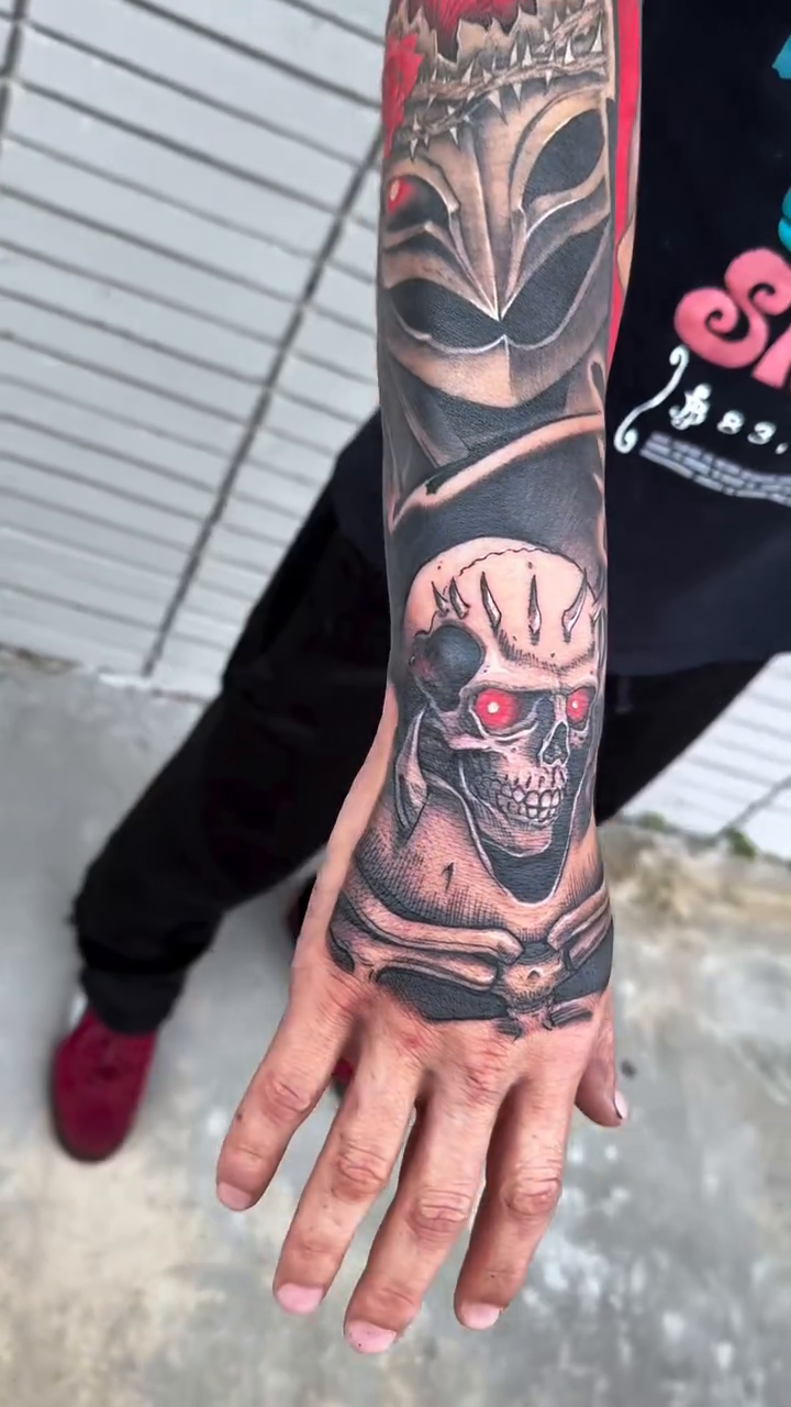 Berserk characters sleeve realism tattoo on the upper arm by Michael Bogle