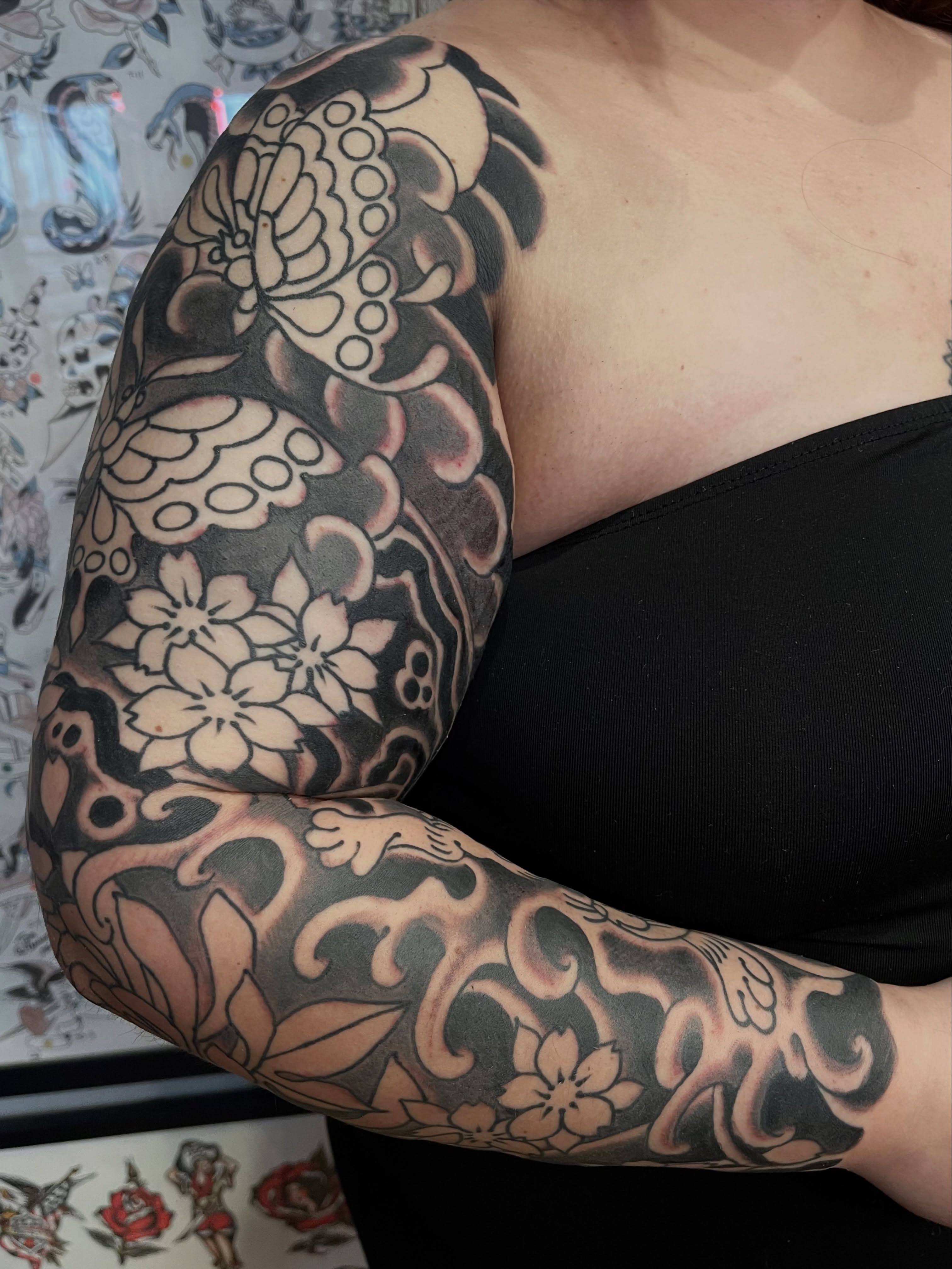 Floral and ornamental ornamental tattoo on the upper arm by Alex Garcia - Sac City Tattoo
