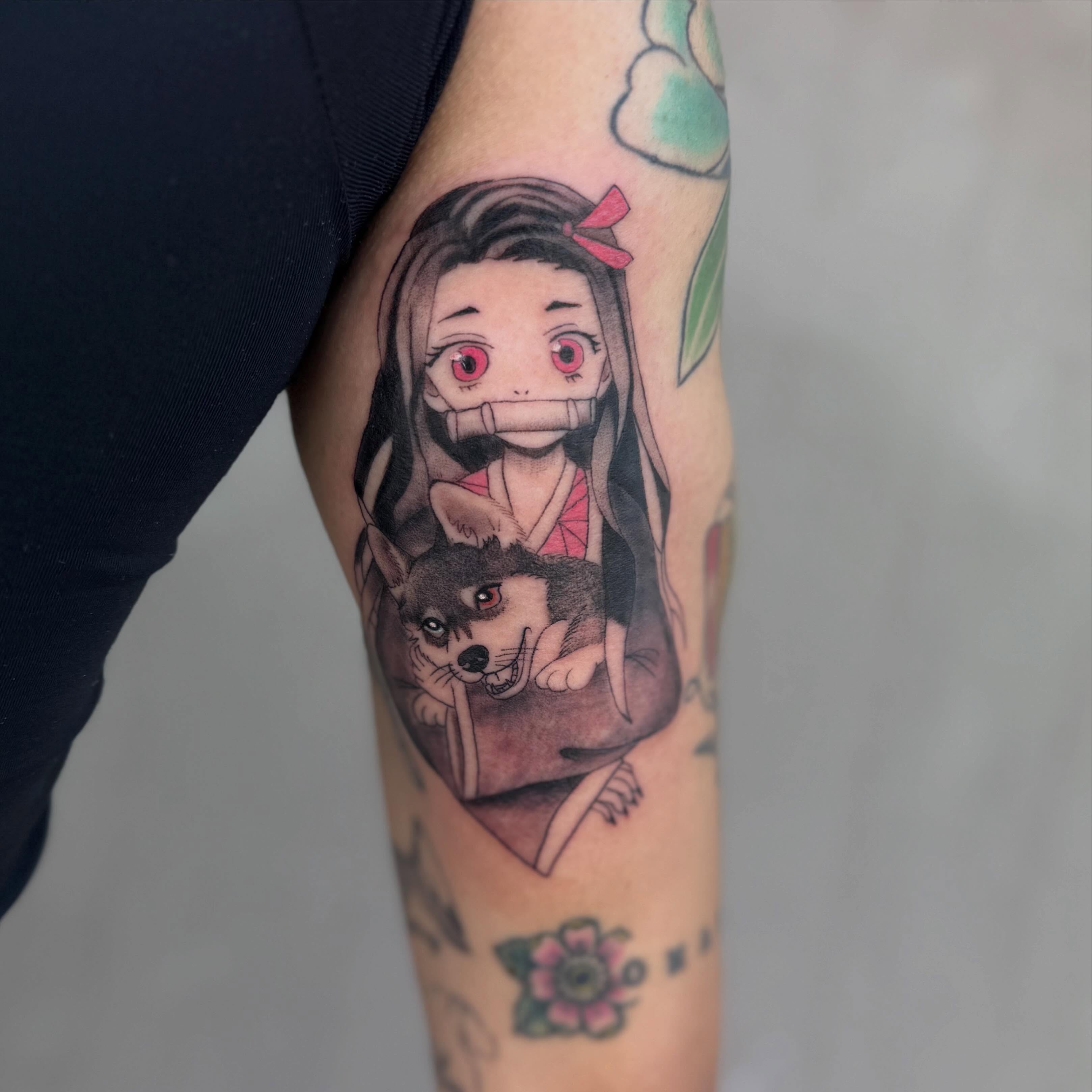 Anime girl with dog anime tattoo on the forearm by Faith Lopez