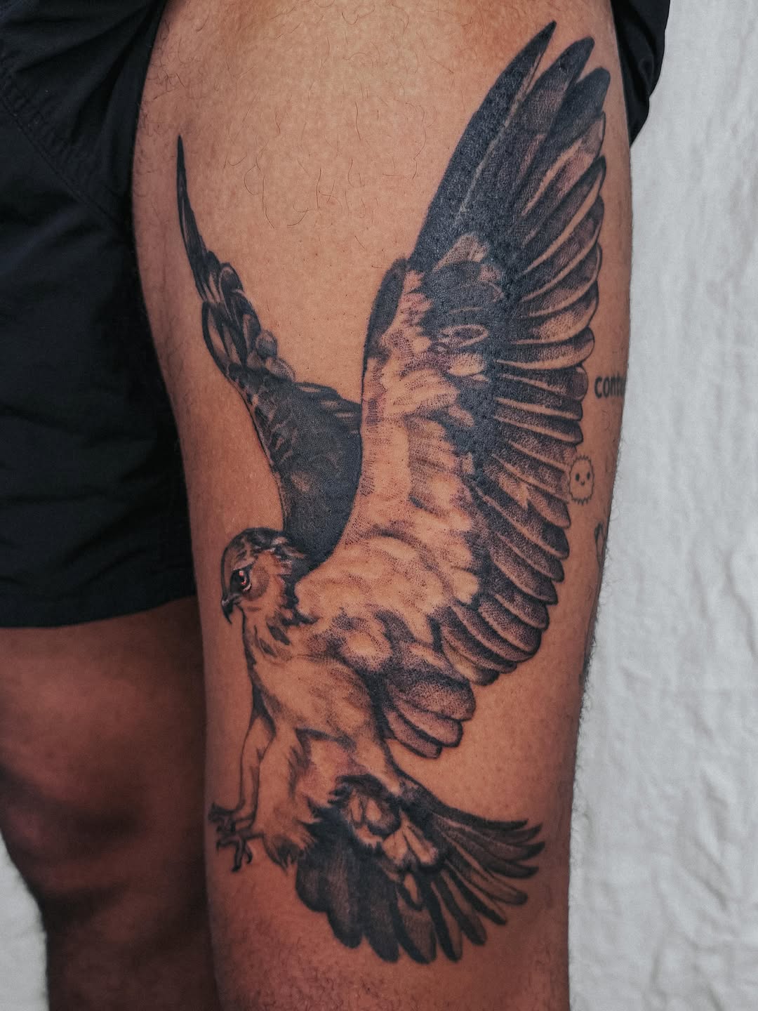 Eagle in flight fine line tattoo on the thigh by Lucy Yin