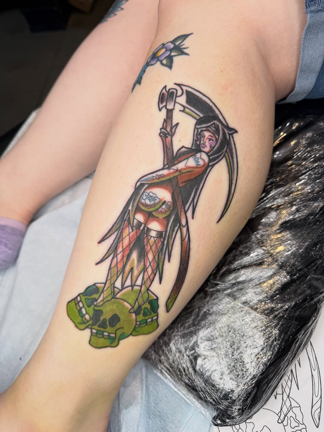 Grim reaper with skulls neo-traditional tattoo on the thigh by Mercy Dean
