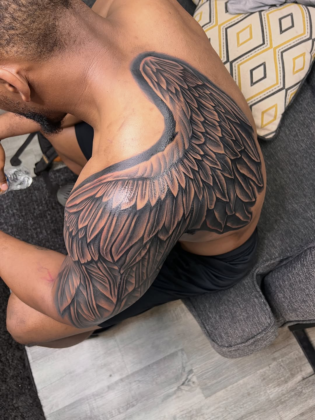 Angel wing realism tattoo on the shoulder by Deonte Dwayne Durham