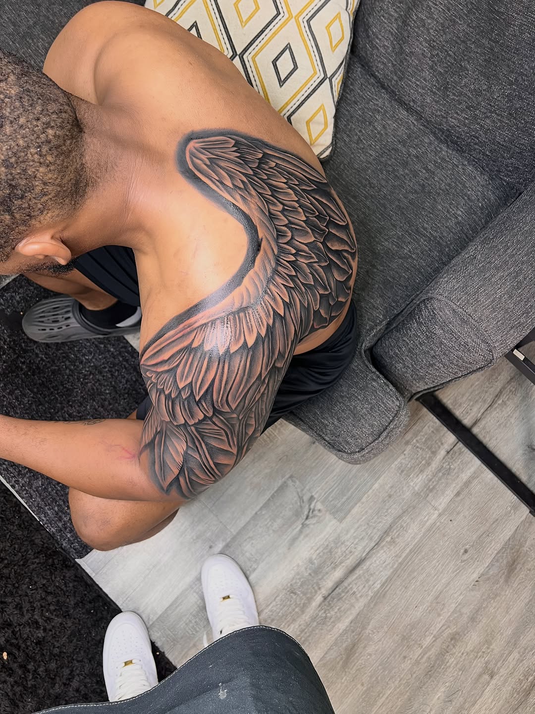 Angel wing realism tattoo on the shoulder by Deonte Dwayne Durham