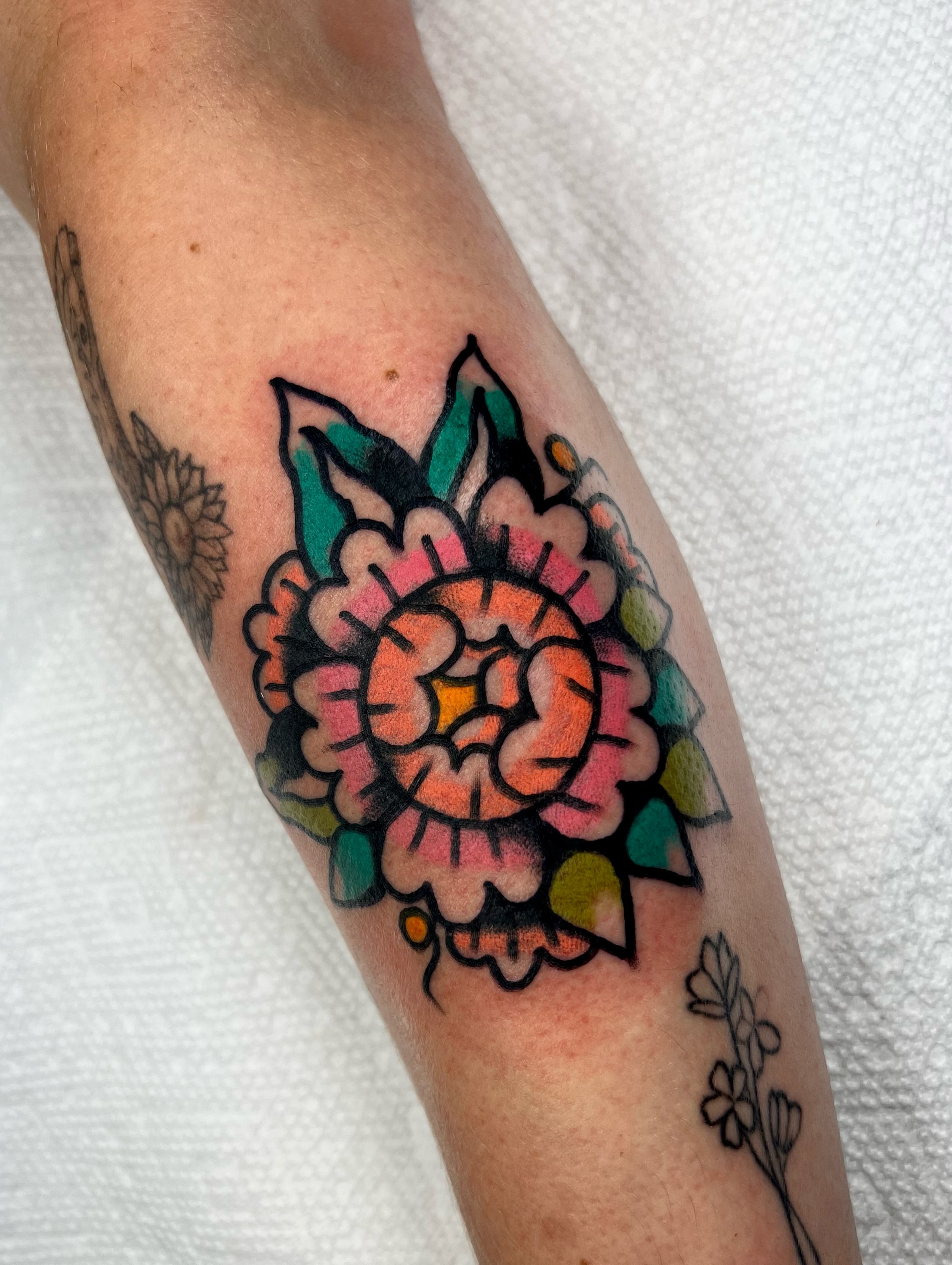 Floral bouquet American traditional tattoo on the forearm by Sierra Mack