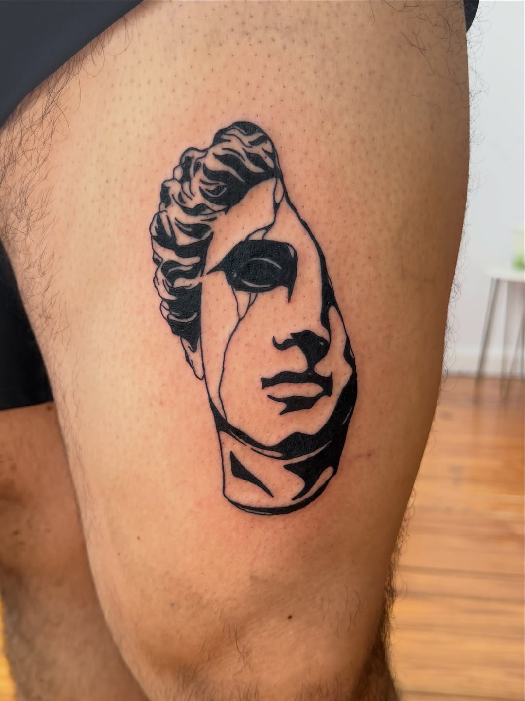 Broken statue head surrealism tattoo on the thigh by Jose Javier