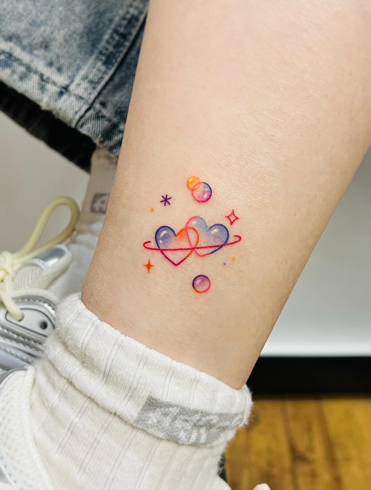 Galaxy watercolor tattoo on the forearm by Purinn
