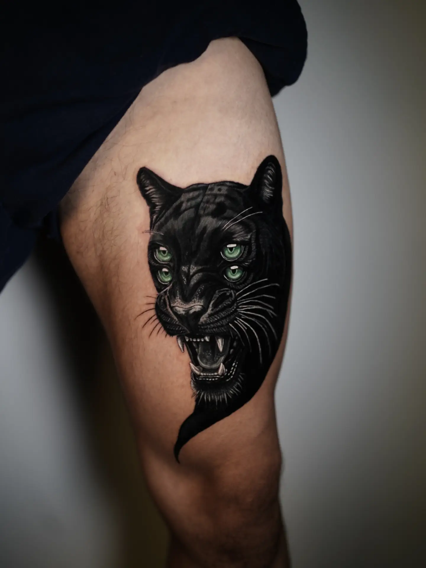 Panther realism tattoo on the thigh by Antonio Arias
