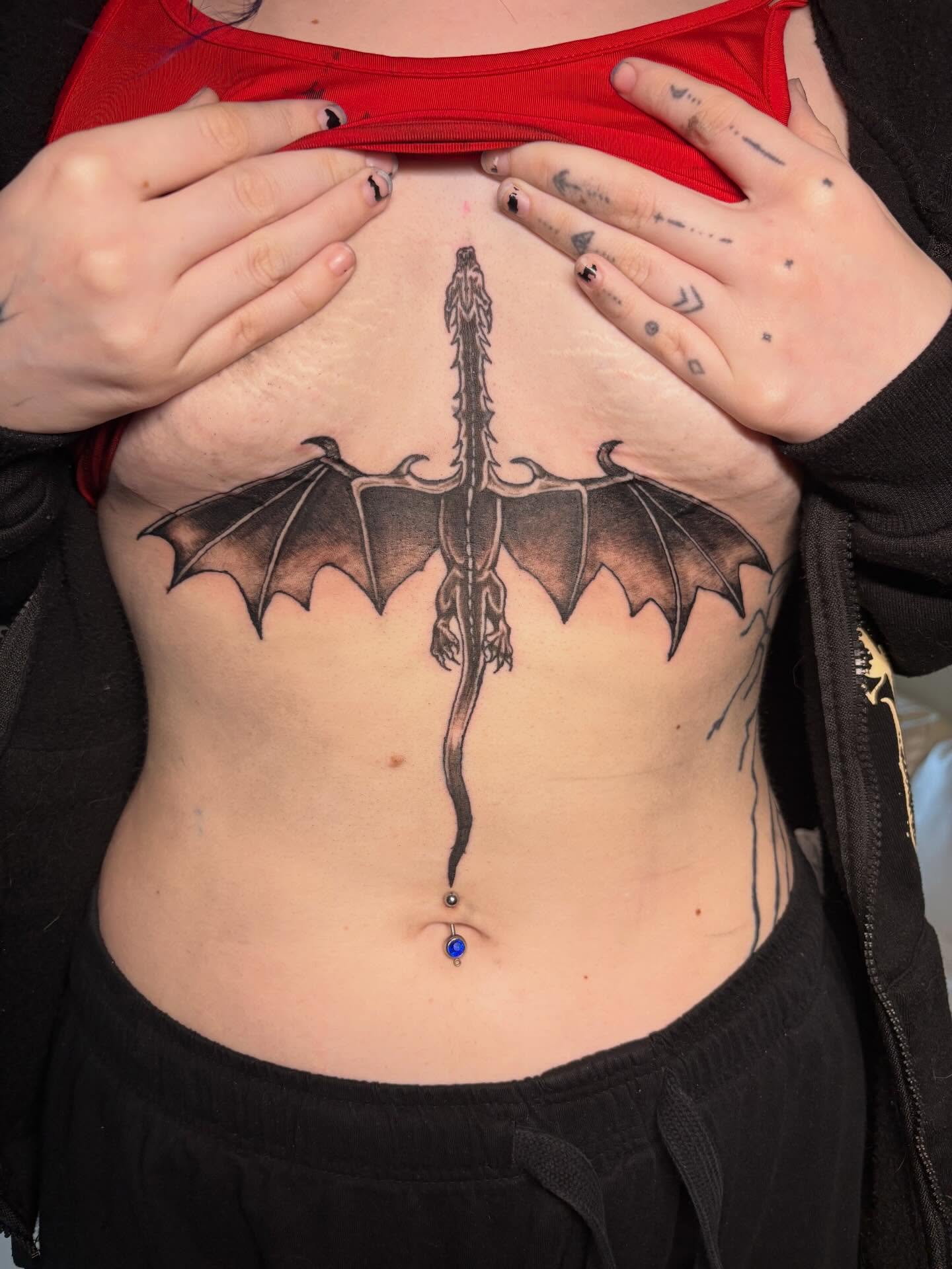 Dragon black and grey tattoo on the ribs by K.L Tattoo Uptown