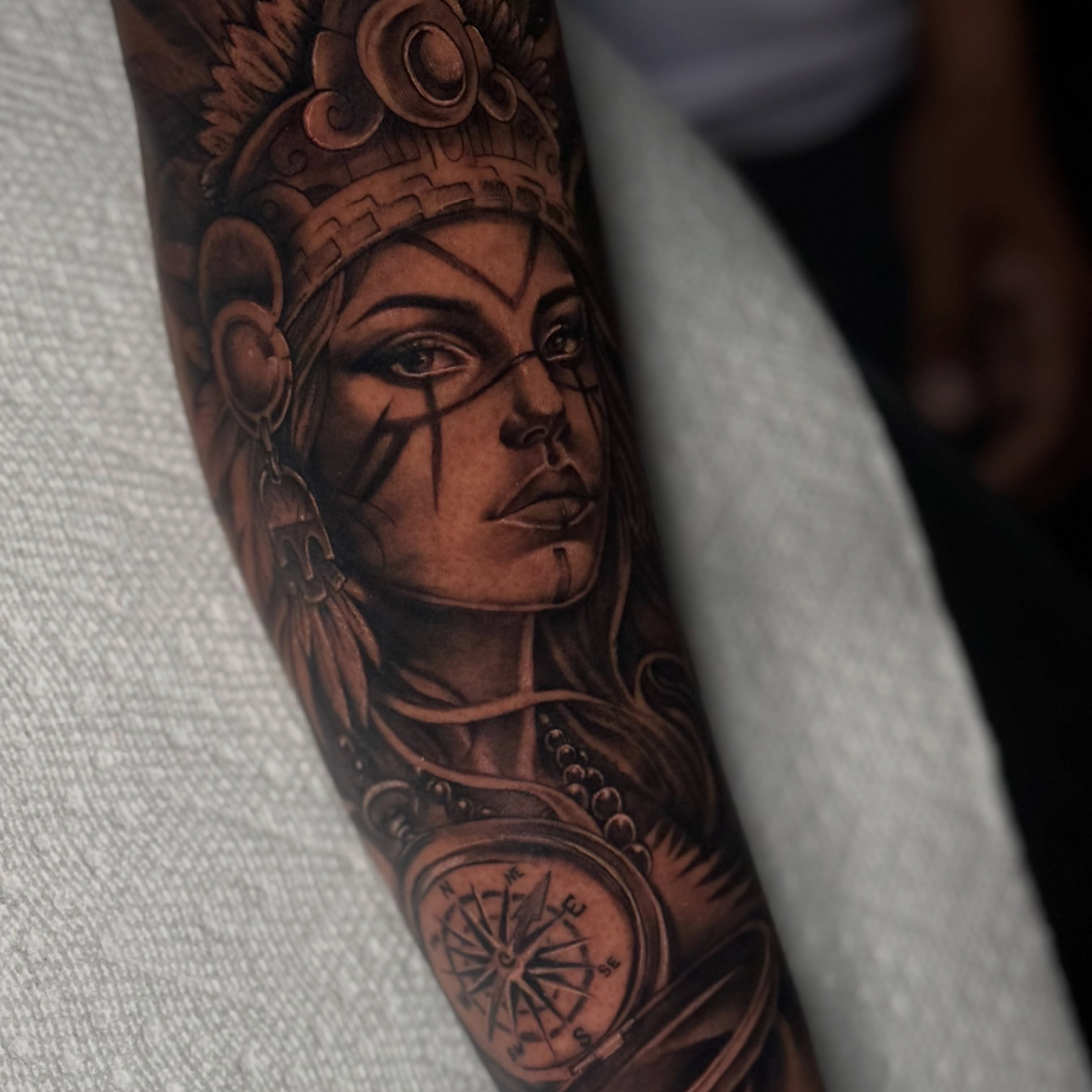 Indian woman with compass realism tattoo on the forearm by Indiana Tattoo Artist