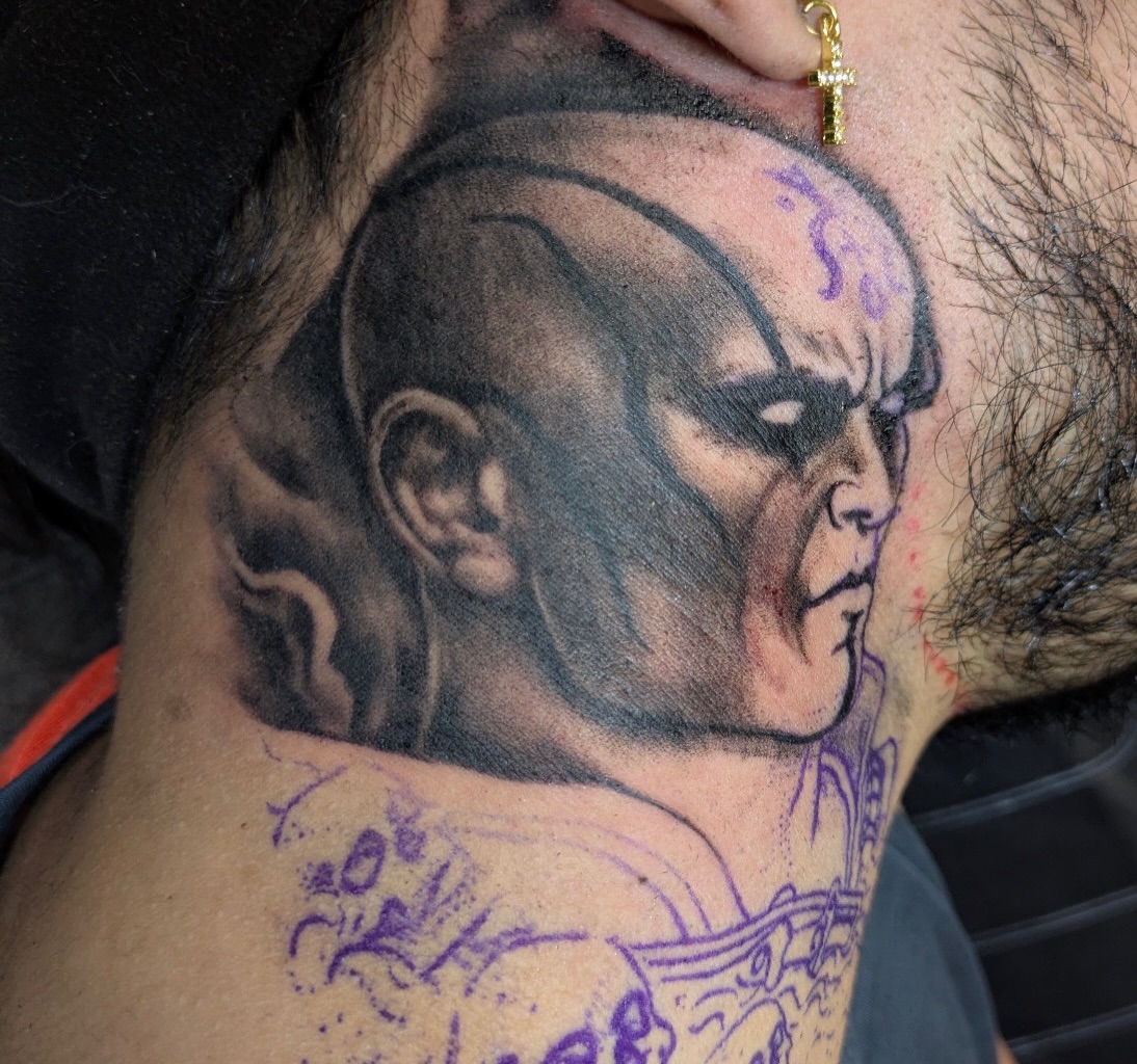 Man's head realism tattoo on the neck by Buddy K.