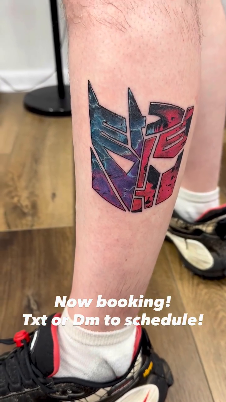 Transformers Autobot and Decepticon logos tattoo on the leg by Sk Pierce