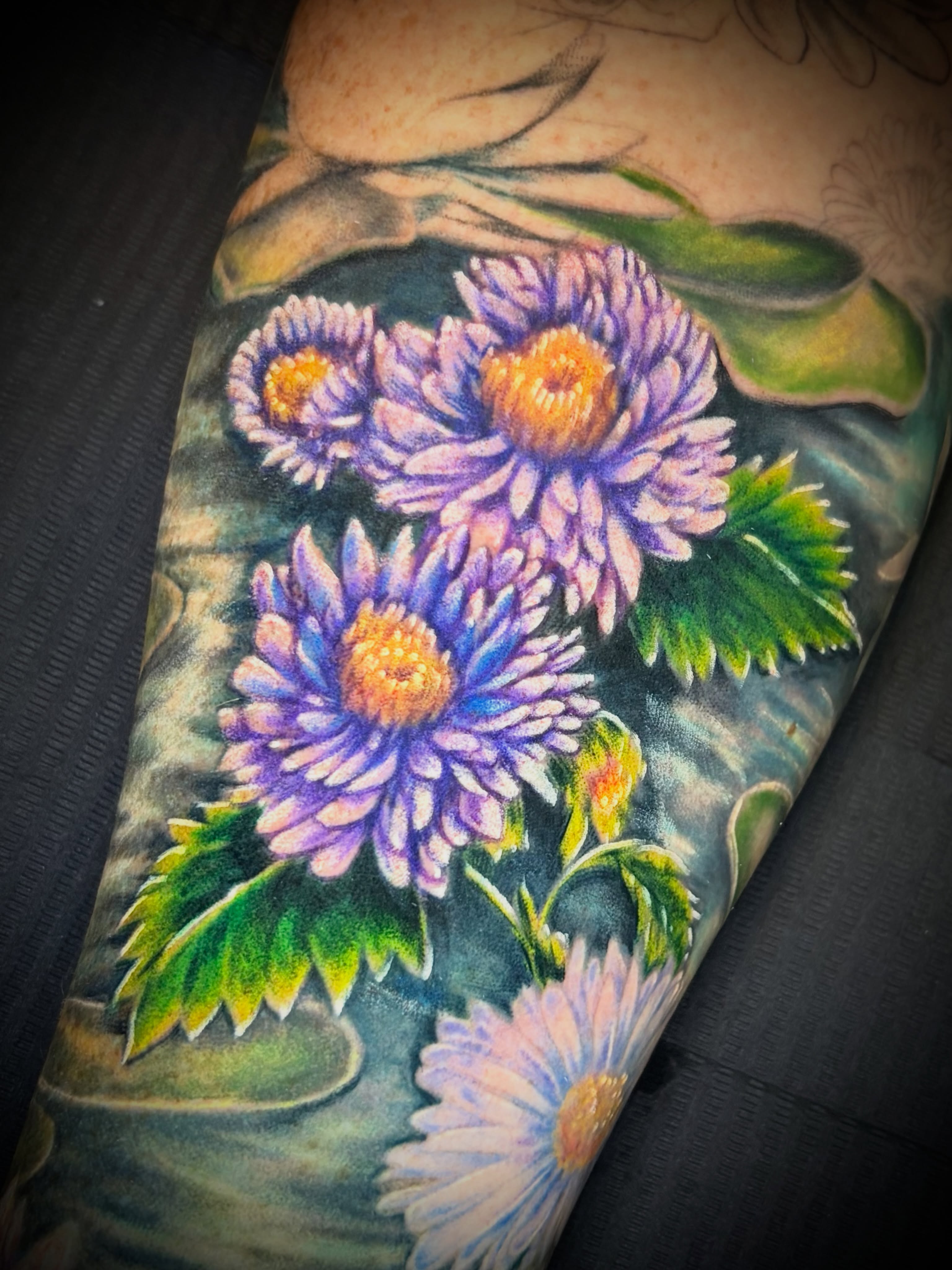 Purple flowers realism tattoo on the forearm by Ali Stanley, Virginia Beach, Virginia