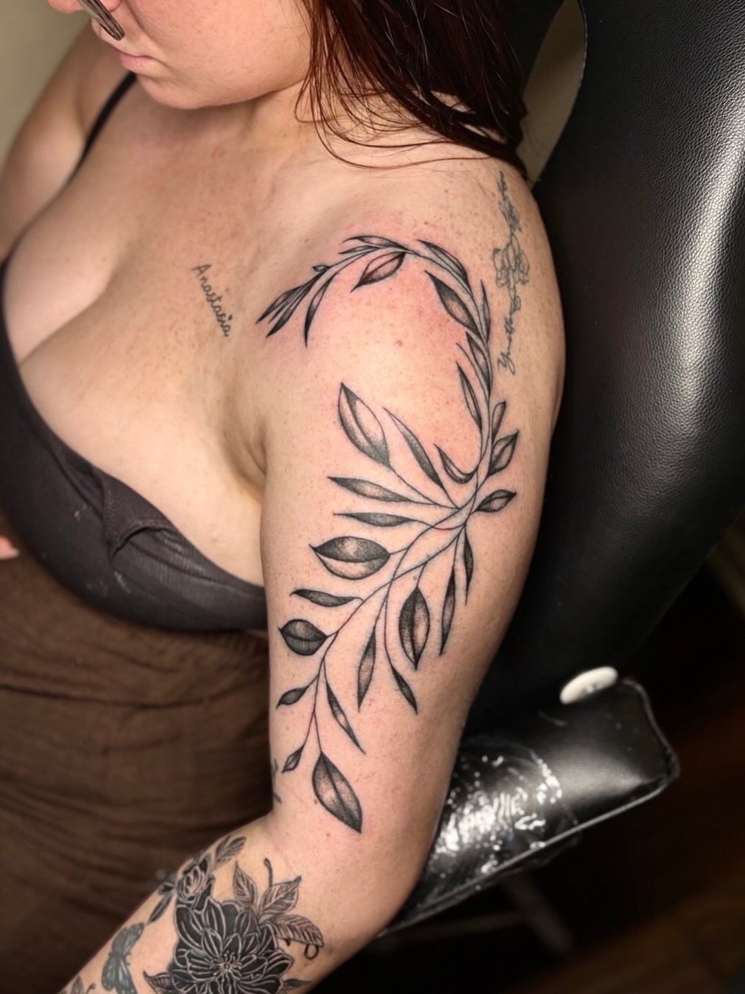 Branch with leaves black and grey tattoo on the shoulder by K.L Tattoo Uptown