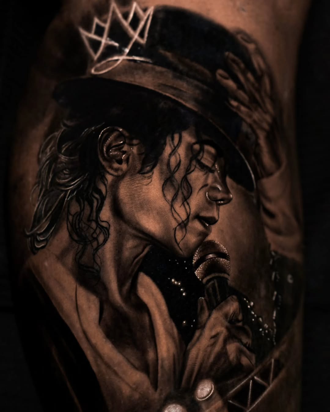 Michael Jackson singing realism tattoo on the upper arm by Baxtertattoo