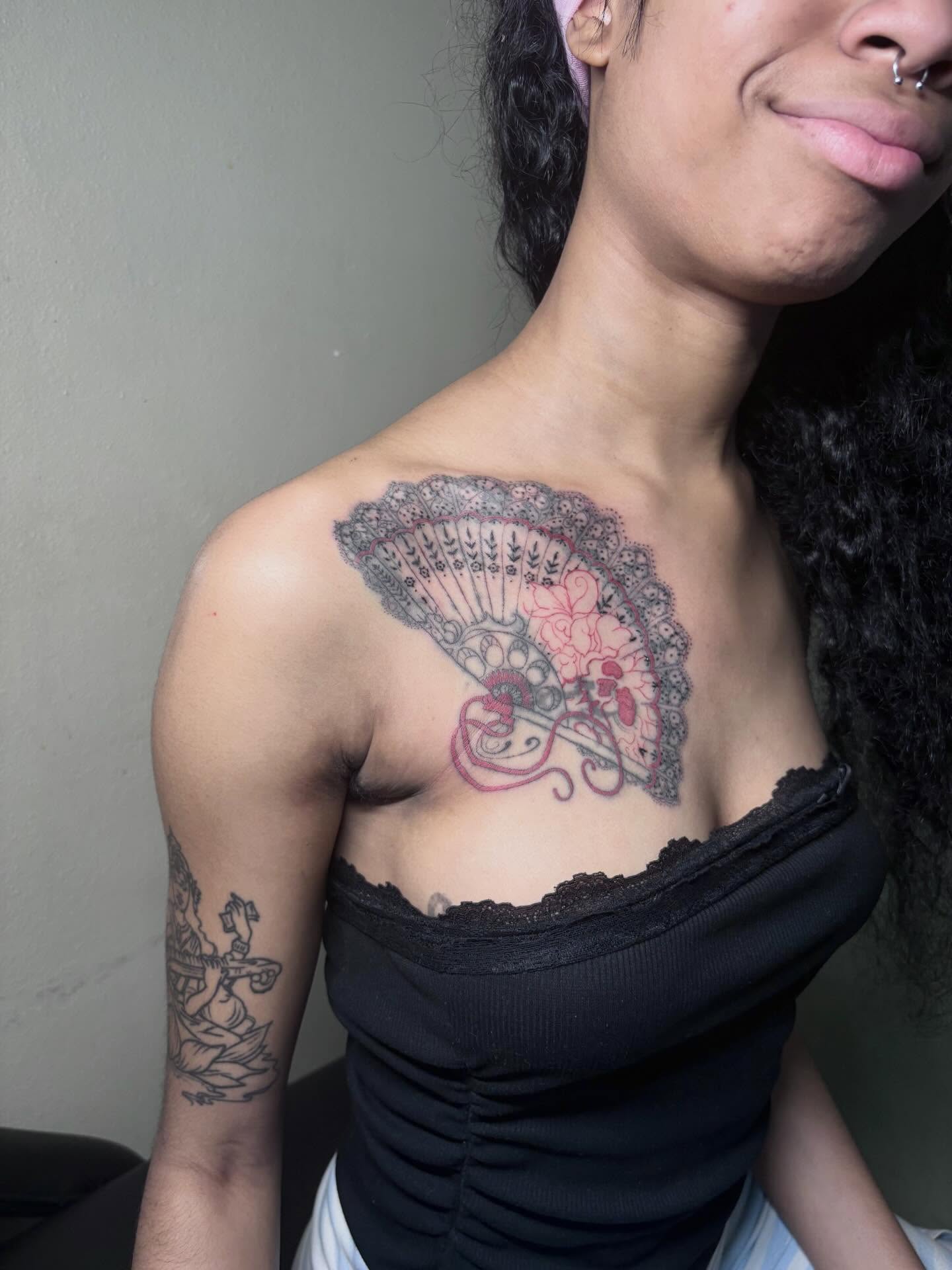 Fan black and grey tattoo on the chest by K.L Tattoo Uptown