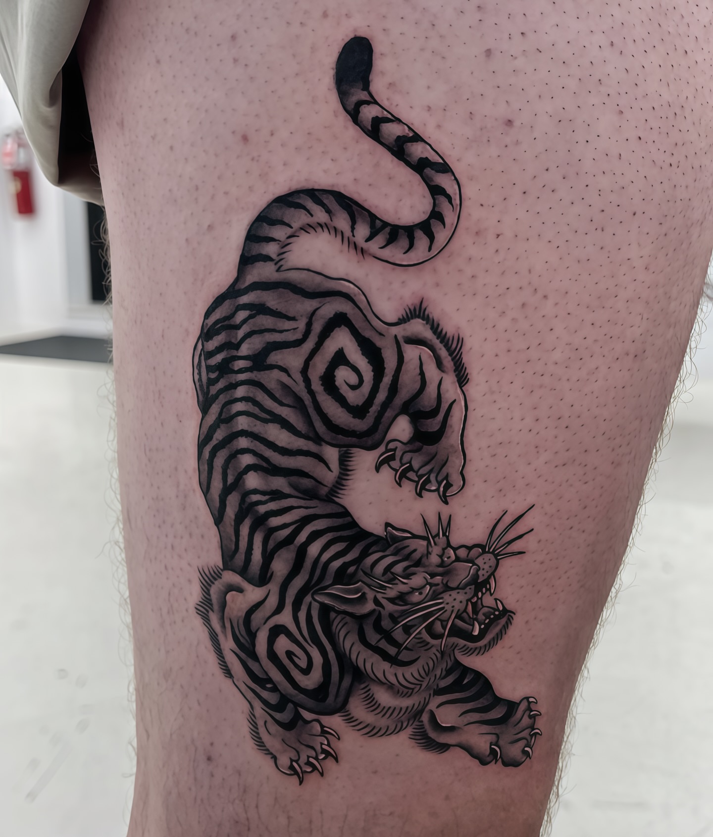 Tiger black and grey tattoo on the thigh by ⚒dptattoos ⚒, East Williamsburg, Brooklyn