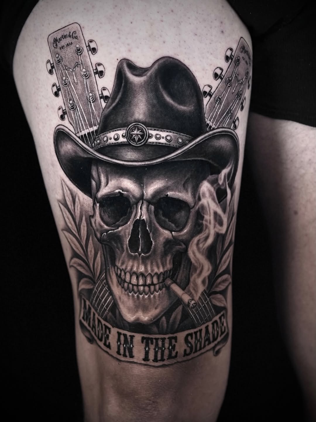 Skull with cowboy hat and guitars realism tattoo on the forearm by Lynn Hoang, Honolulu, Hawaii