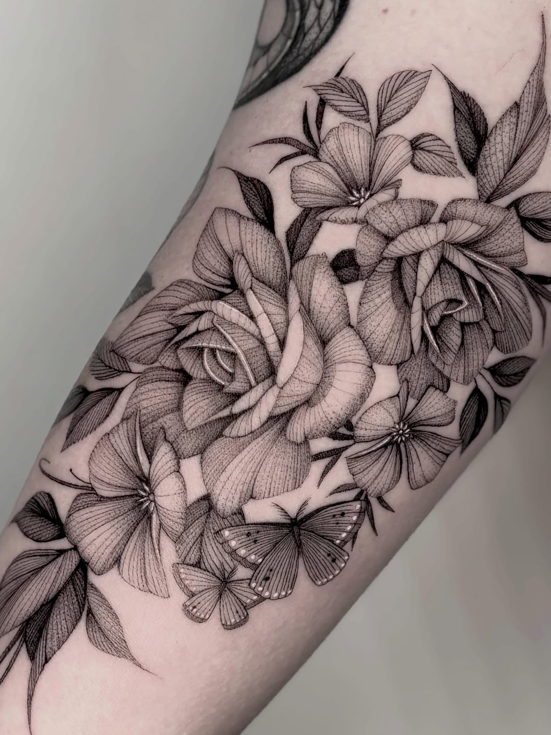 Roses and butterflies dotwork tattoo on the forearm by Brittney Naami, San Francisco, California
