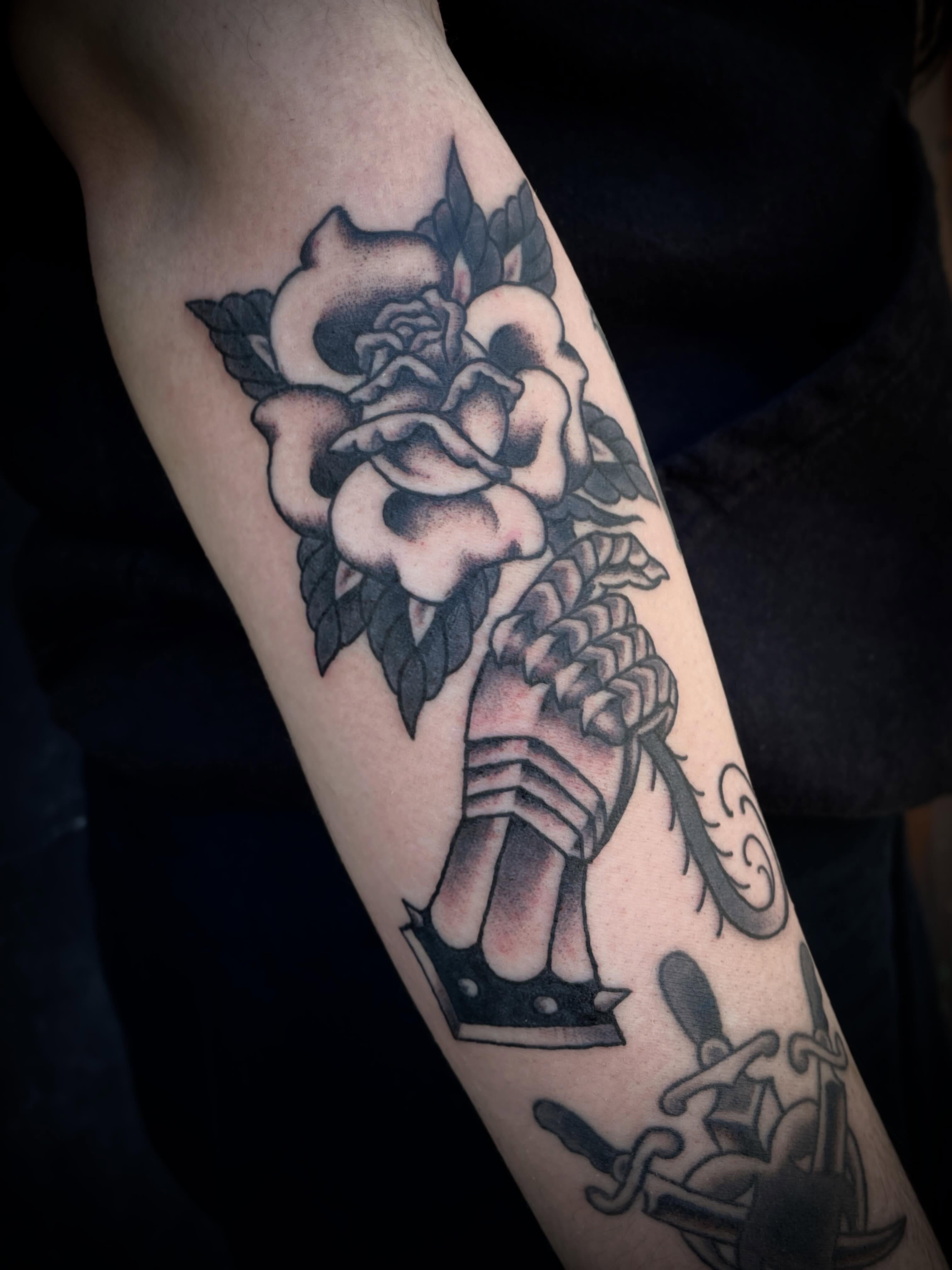 Rose and anchor American traditional tattoo on the forearm by Nick Wallin