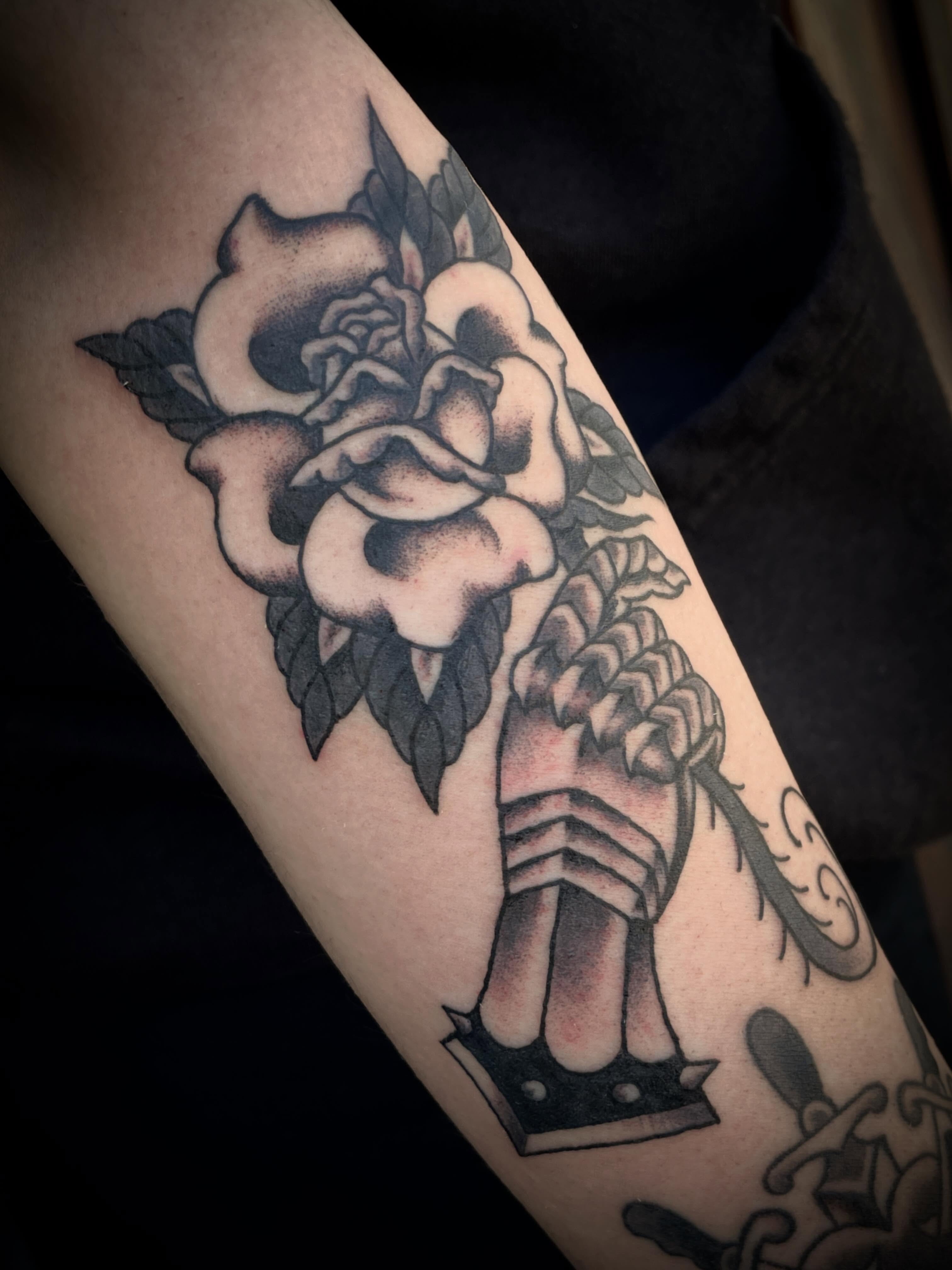 Rose and boot American traditional tattoo on the forearm by Nick Wallin