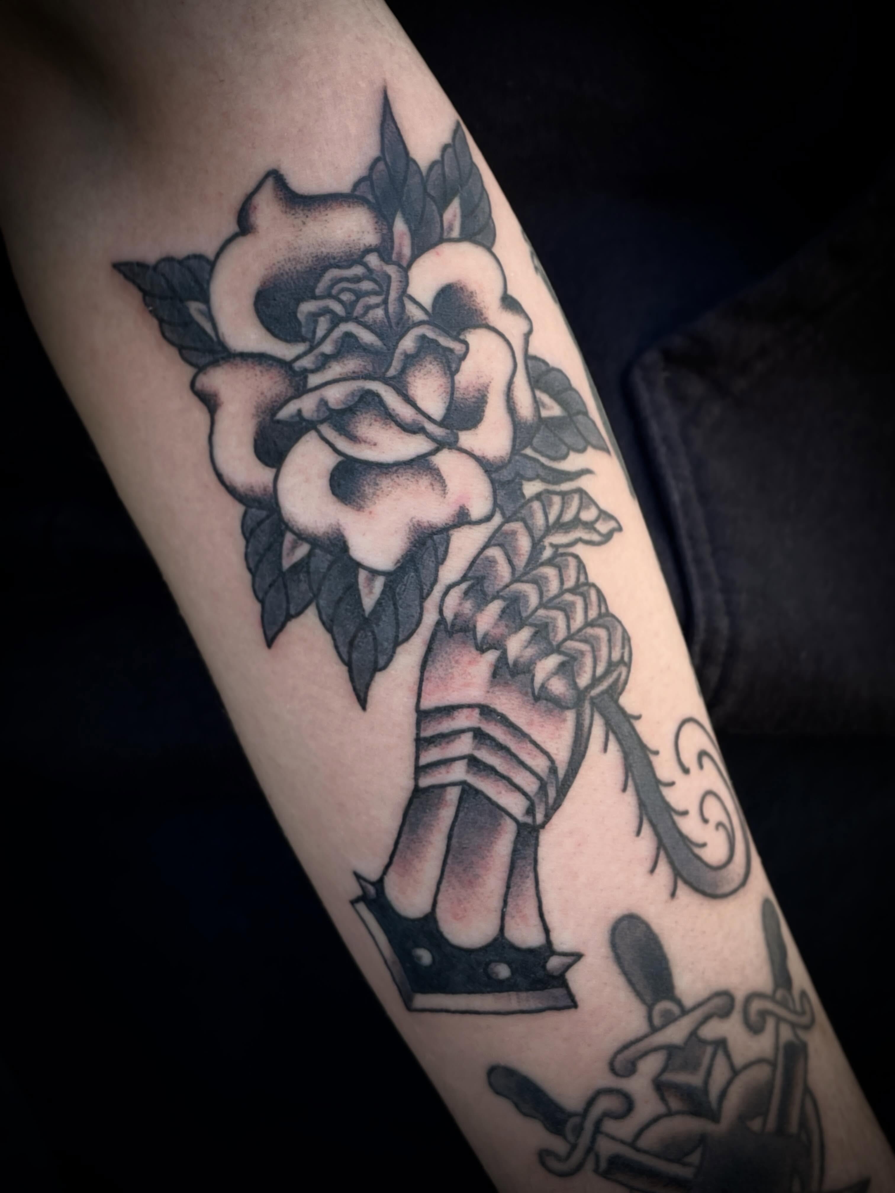 Rose and rope American traditional tattoo on the forearm by Nick Wallin