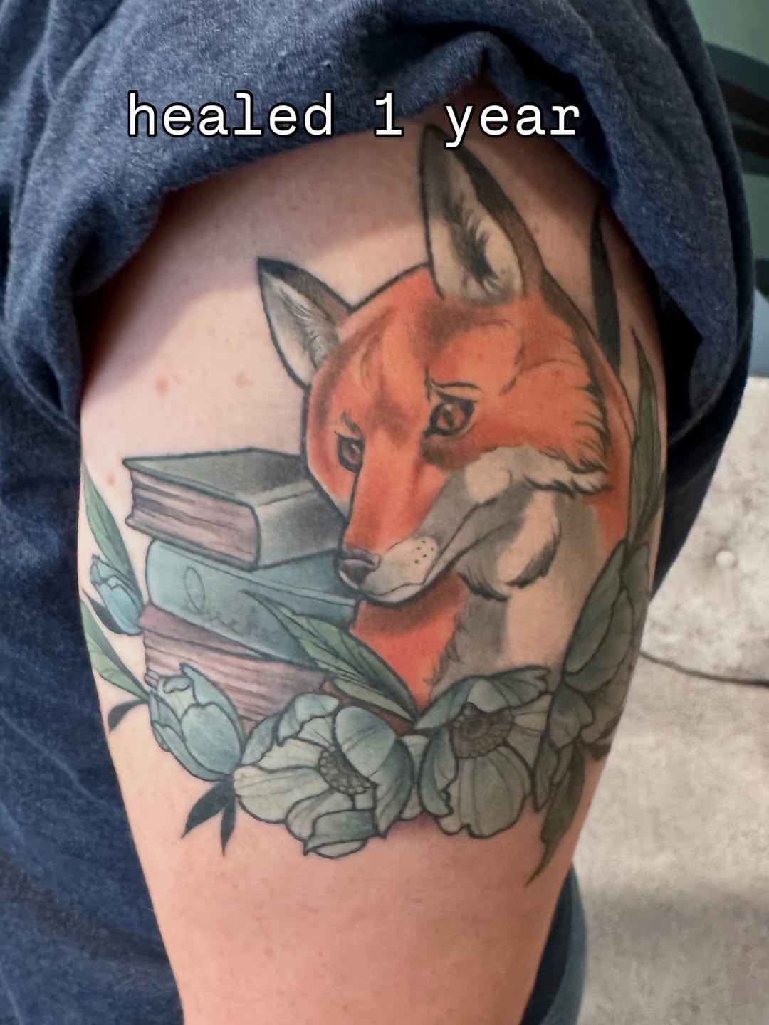 Fox with books and flowers neo-traditional tattoo on the upper arm by Katie Hutchins, Dayton, Ohio