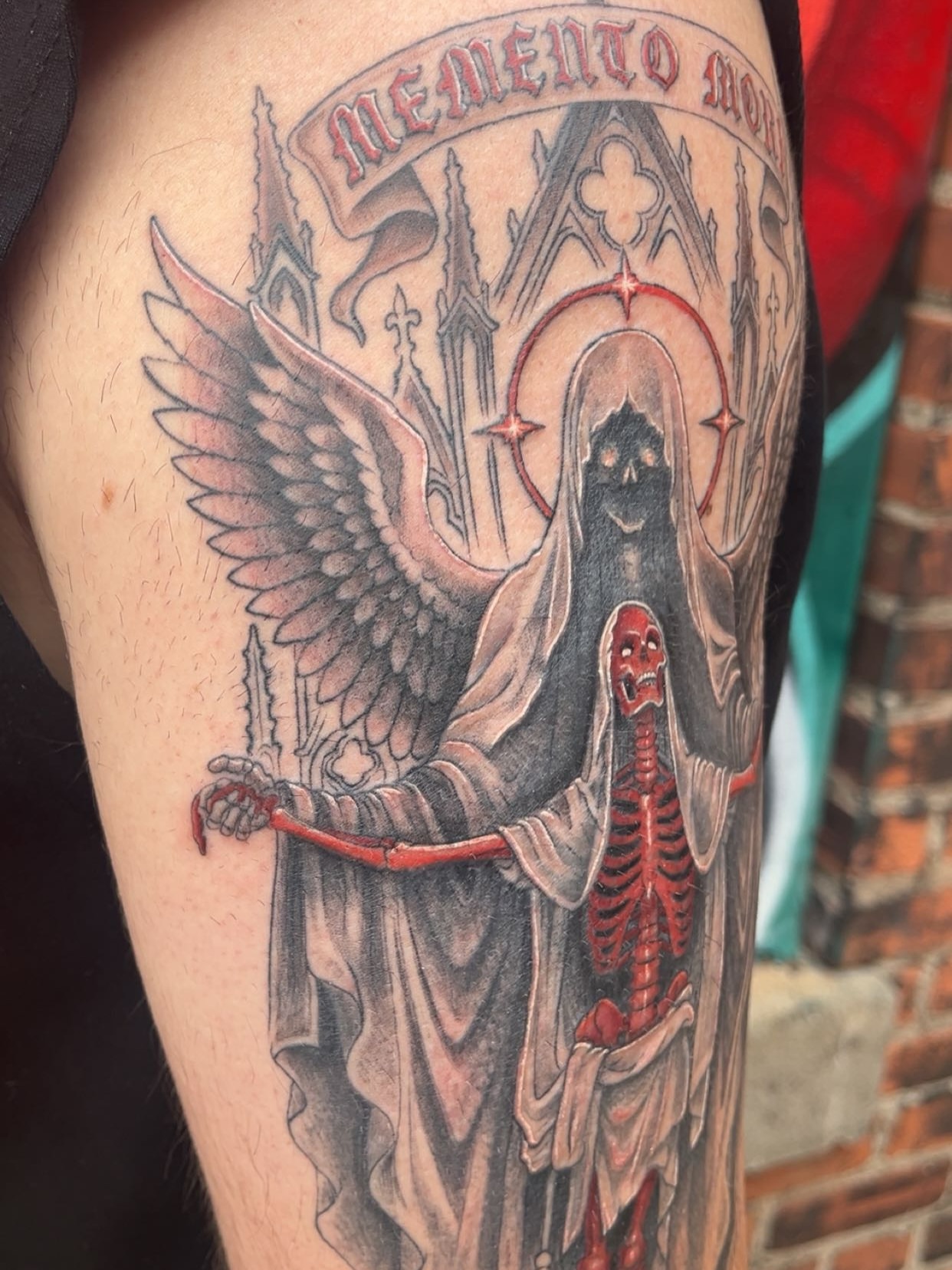 Reaper holding skeleton dark realism tattoo on the forearm by Elle Miller