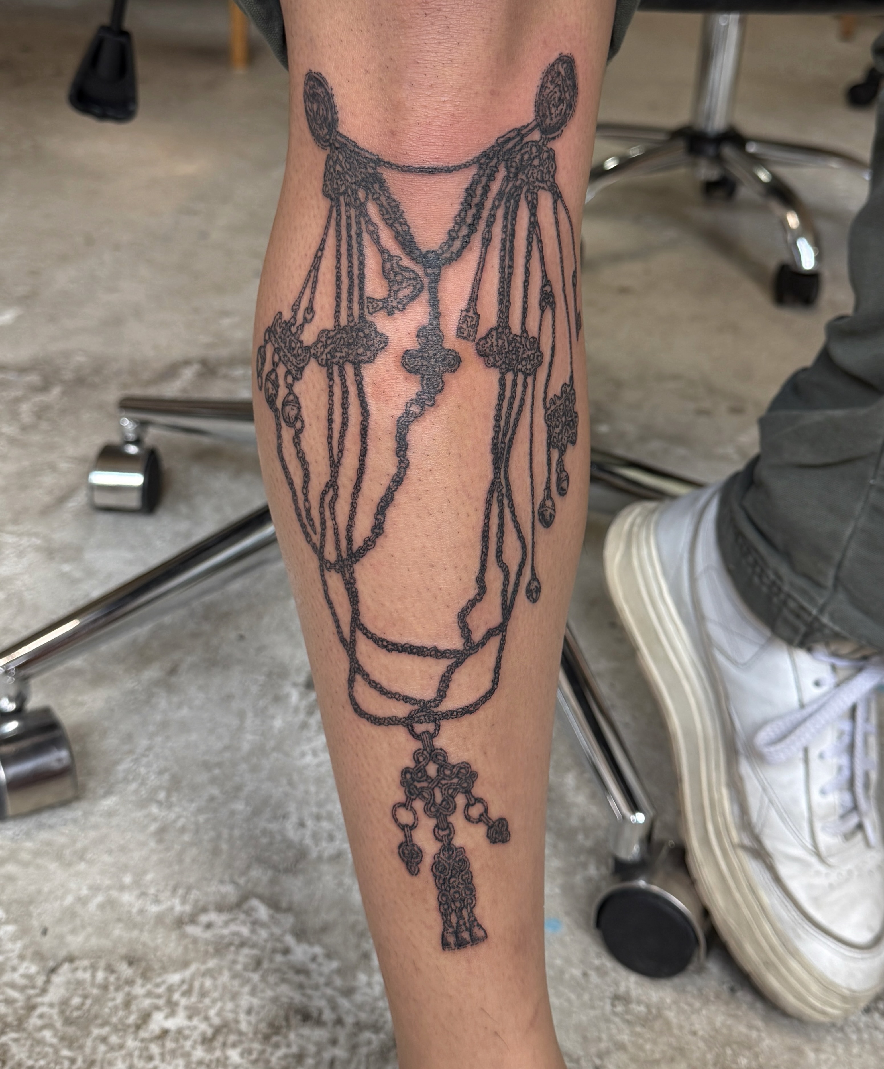 Rosary black and grey tattoo on the forearm by Penelope
