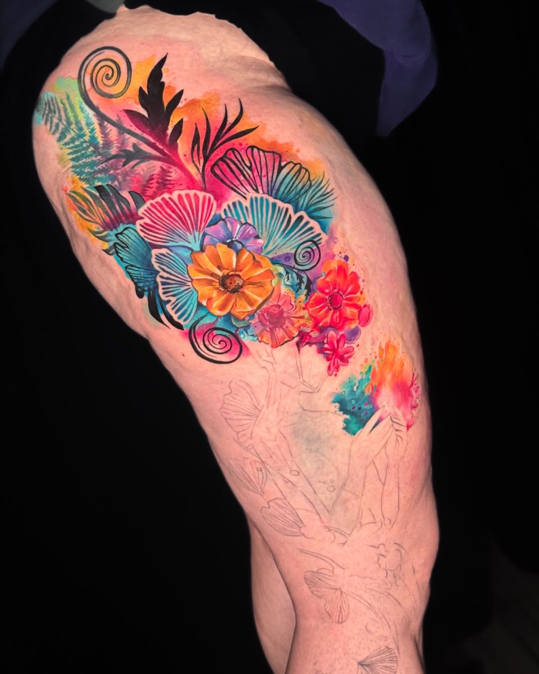 Floral arrangement watercolor tattoo on the upper arm by Amy Zager