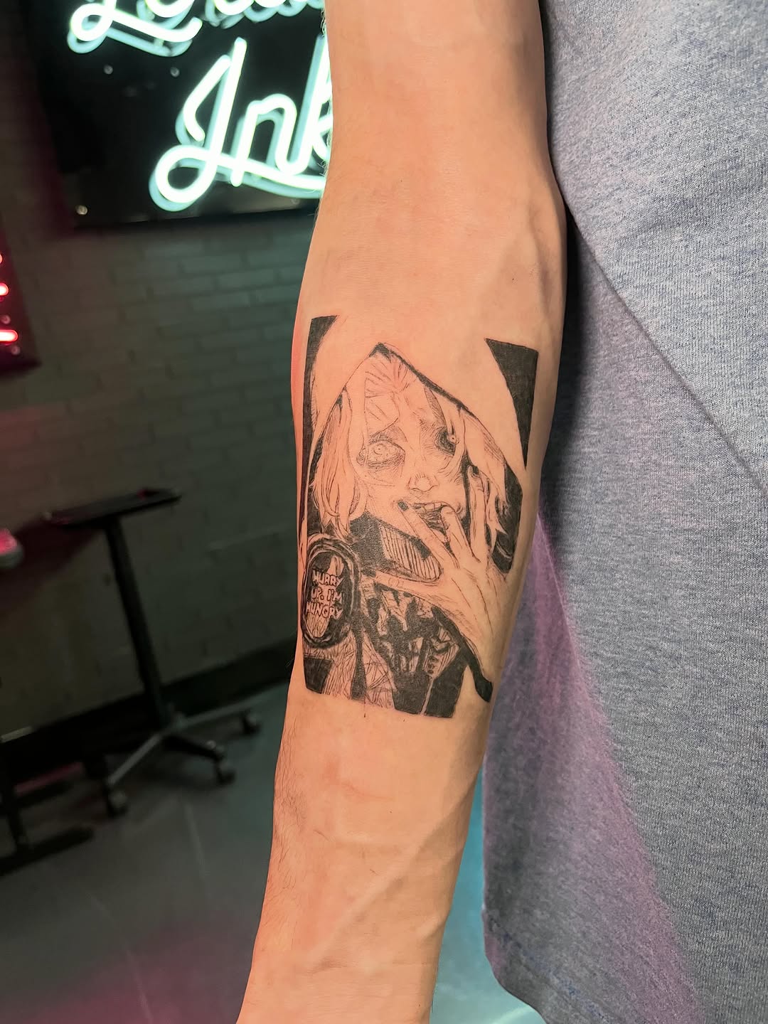 Zombie face with text anime tattoo on the forearm by Bunny 🐰