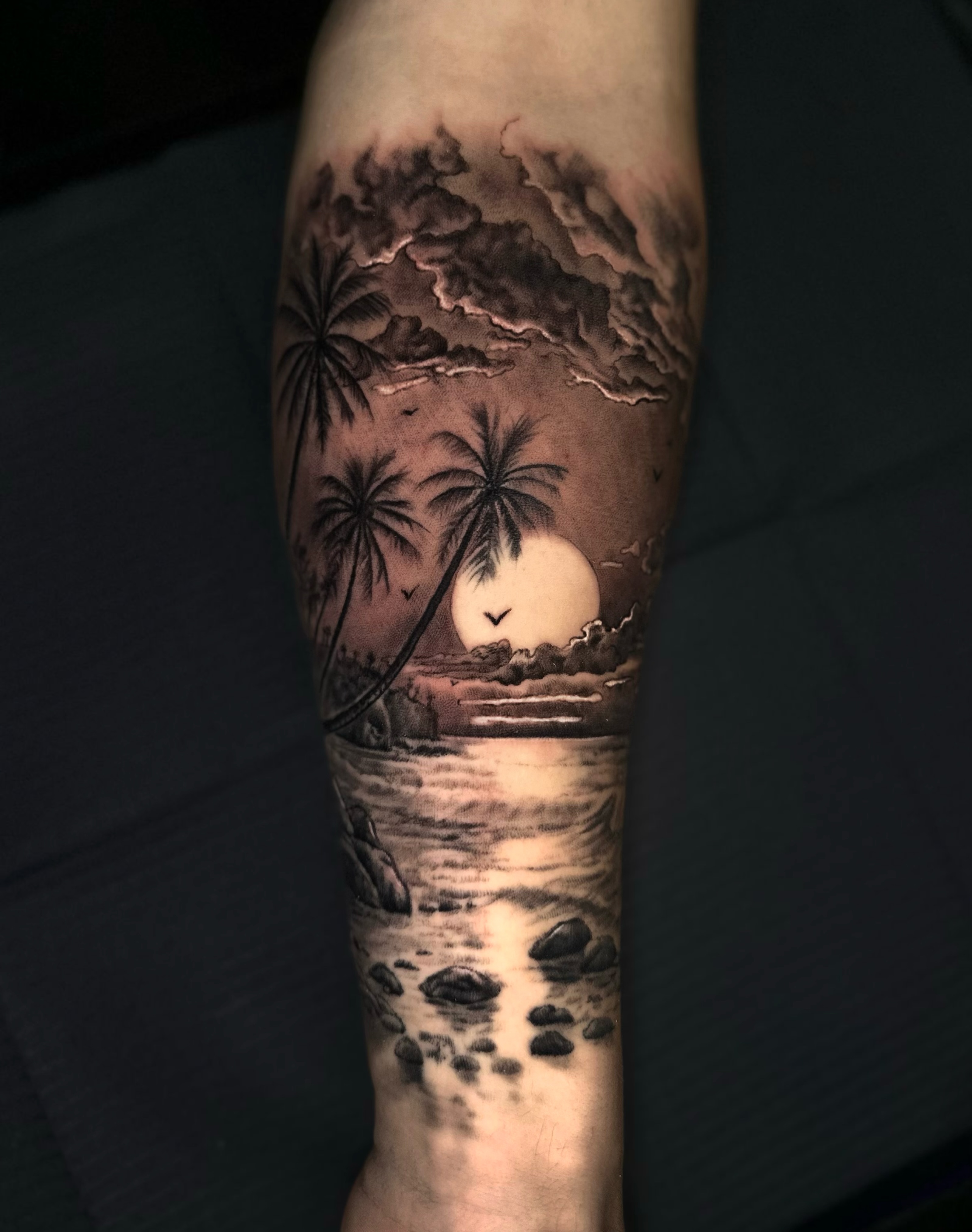 Sunset beach realism tattoo on the forearm by Jesse White, Mentor, Ohio
