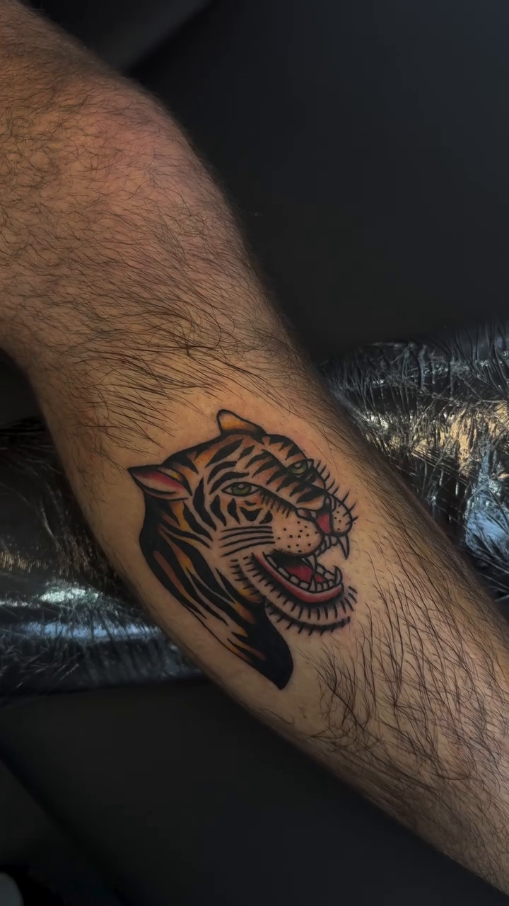 Tiger head tattoo realism tattoo on the forearm by Béle Benard