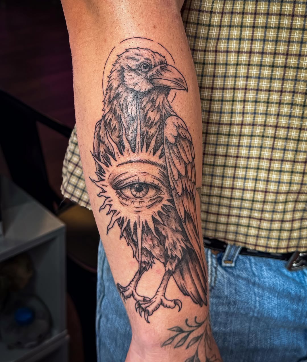 Raven with eye of providence fine line tattoo on the forearm by Ash✨