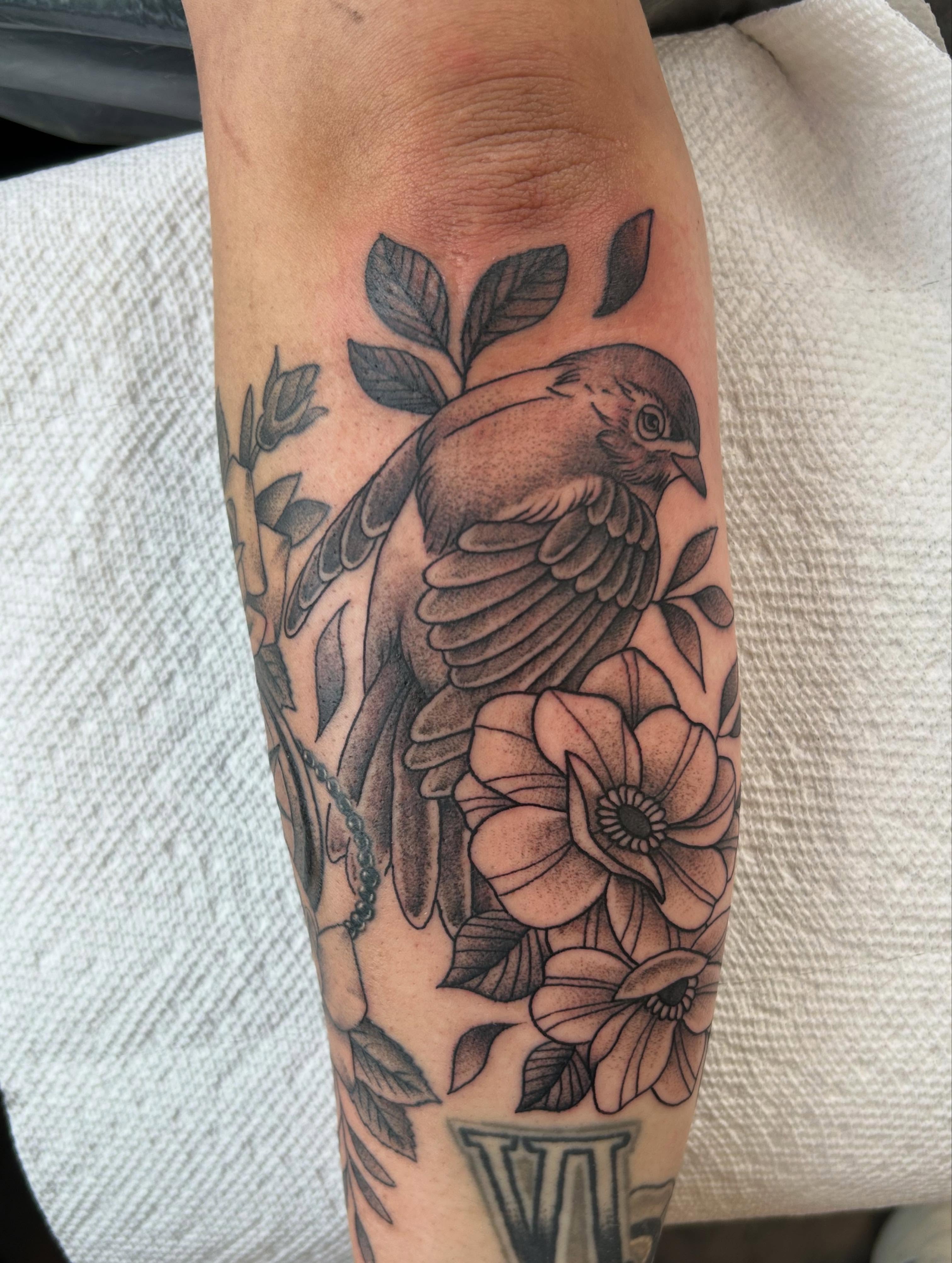 Bird and flowers American traditional tattoo on the forearm by Randy Bray