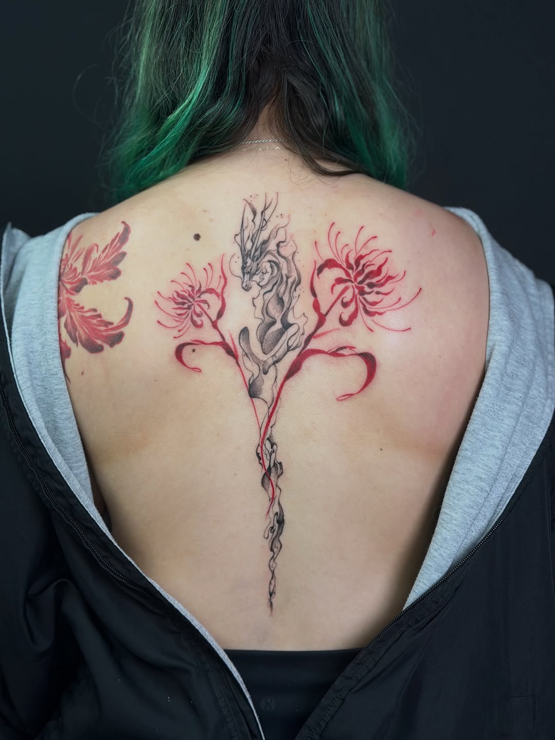 Dragon and spider lilies blackwork tattoo on the back by Vu Nguyen