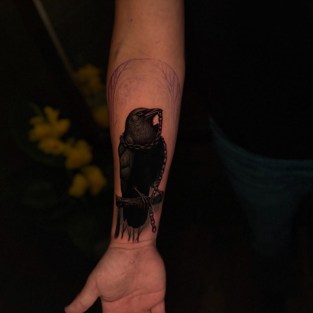Raven with chain dark art tattoo on the forearm by Tay 🥀
