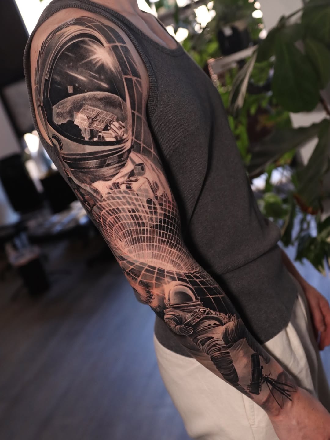 Astronaut in space surrealism tattoo on the upper arm by Naomi Burke, New Westminster, British Columbia