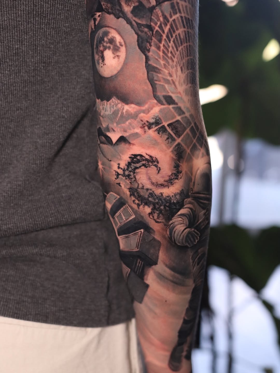 Astronaut and space landscape surrealism tattoo on the forearm by Naomi Burke, New Westminster, British Columbia