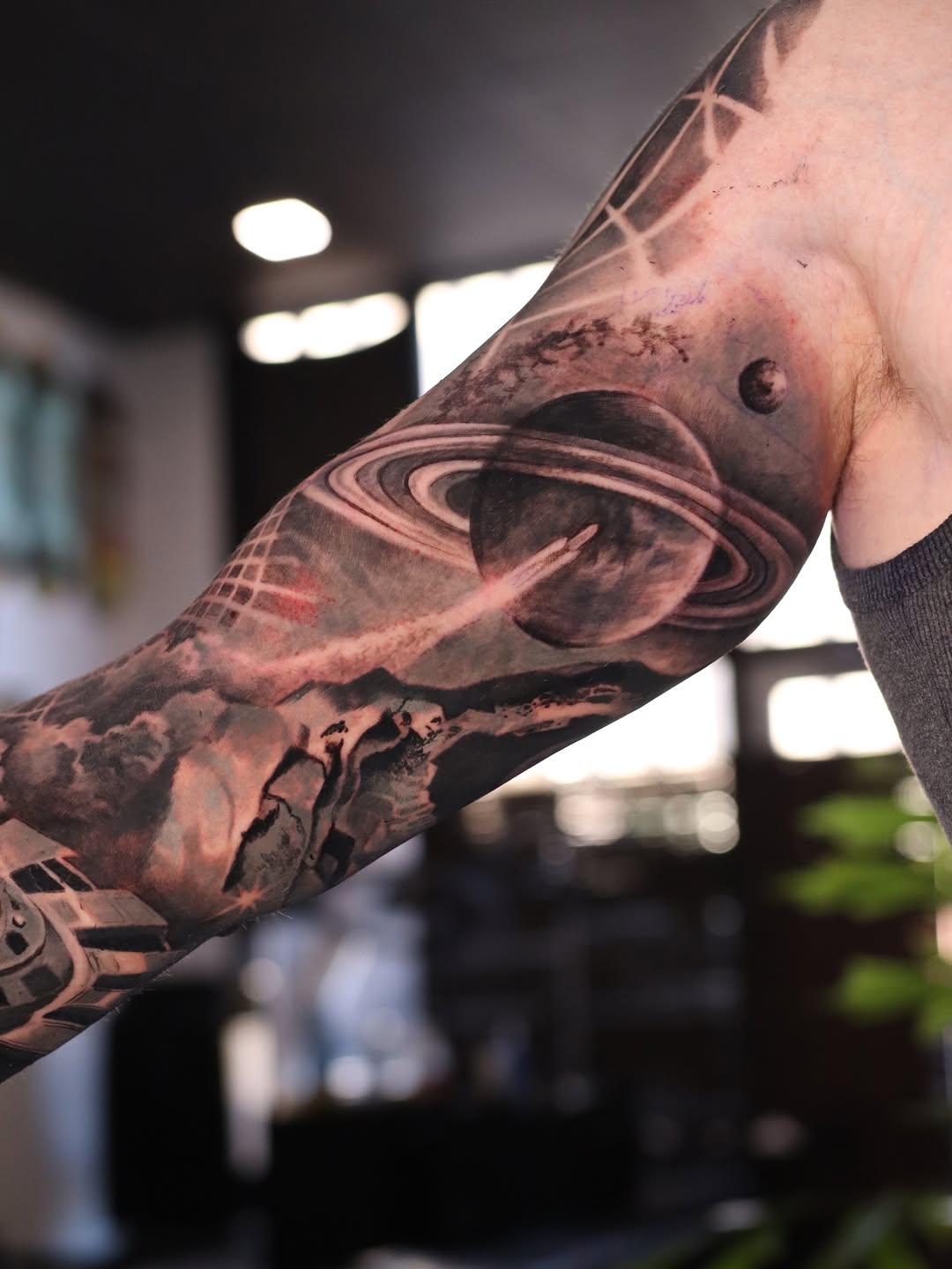 Space scene with planets and spacecraft surrealism tattoo on the forearm by Naomi Burke, New Westminster, British Columbia