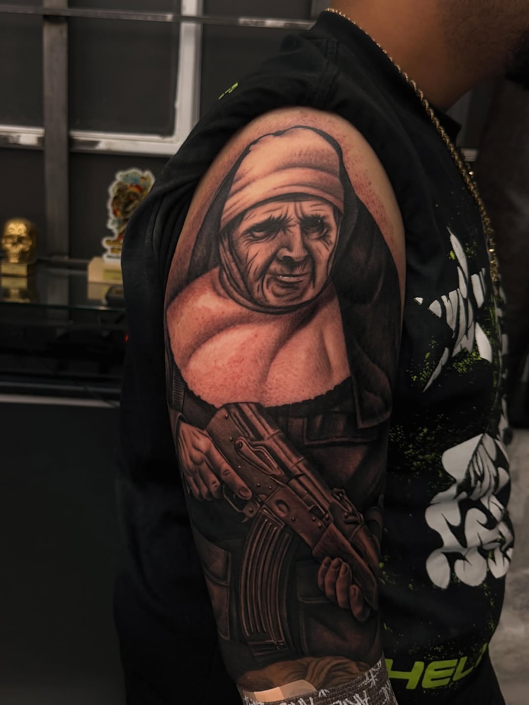 Nun holding a rifle Chicano tattoo on the shoulder by LOS