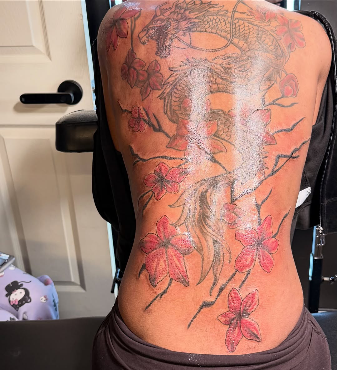 Dragon and cherry blossoms watercolor tattoo on the back by Shine Jefferson, Memphis, Tennessee