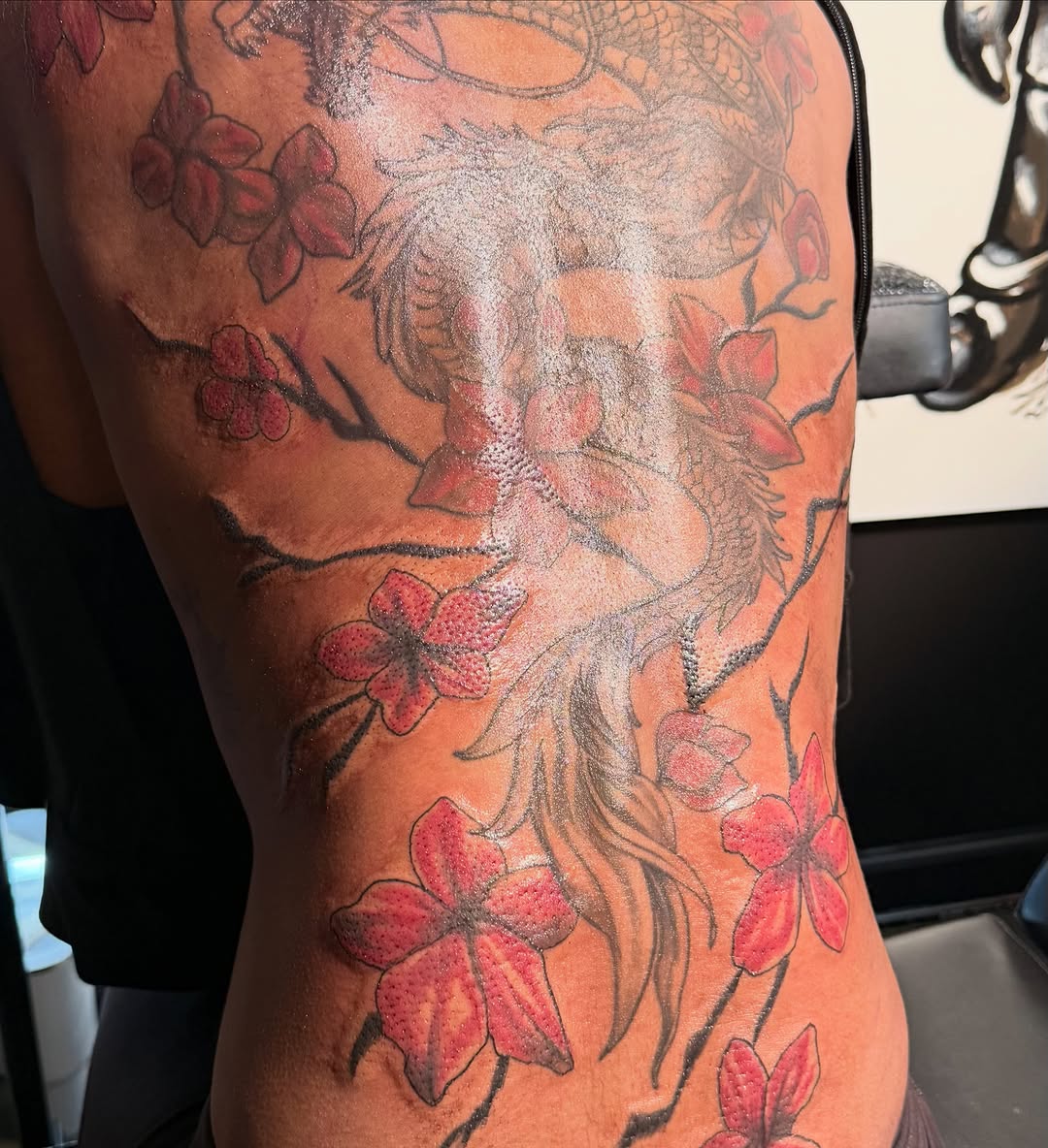 Dragon and cherry blossoms Japanese tattoo on the thigh by Shine Jefferson, Memphis, Tennessee
