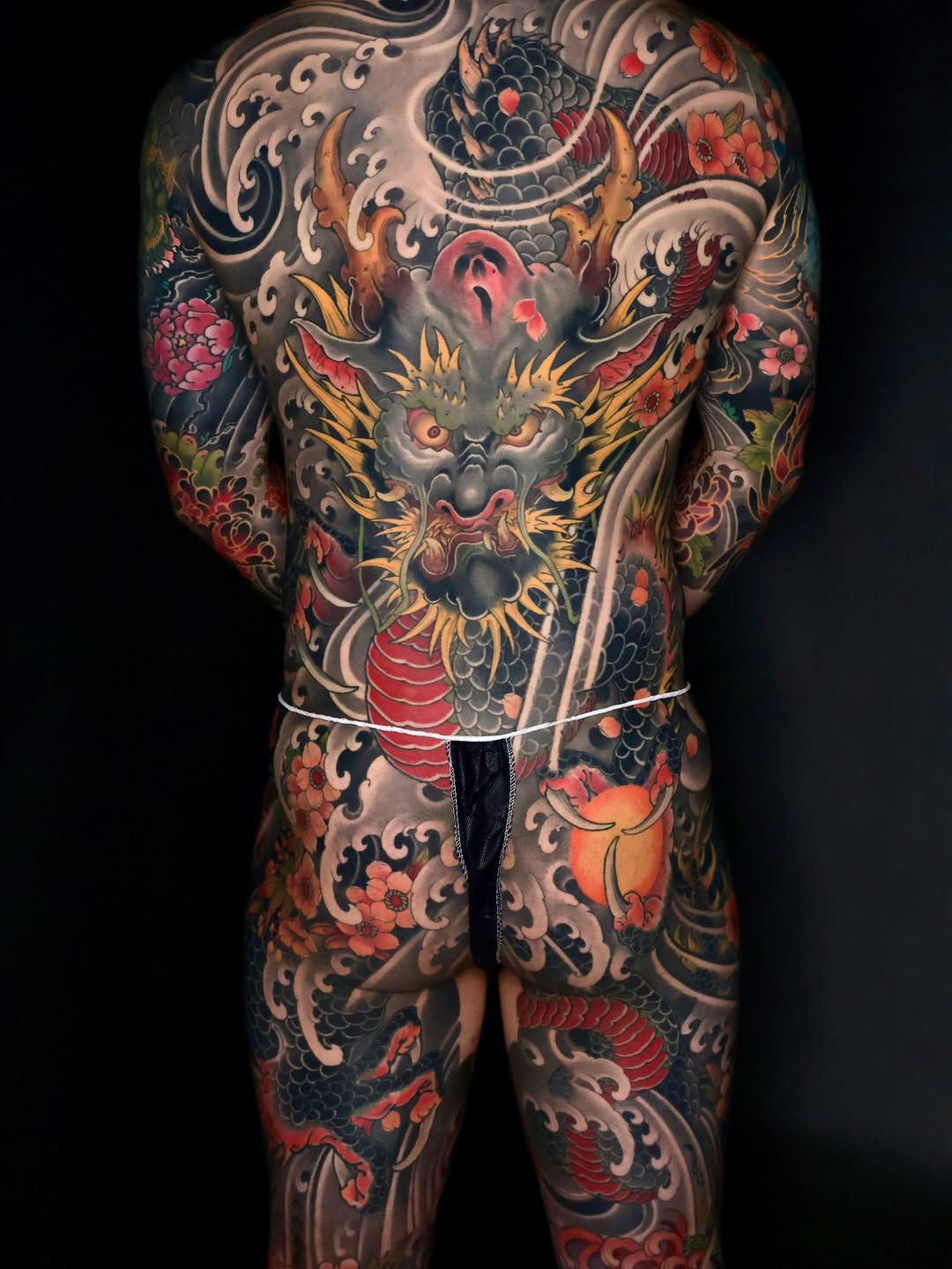 Dragon and floral Japanese tattoo on the torso by Hocheon