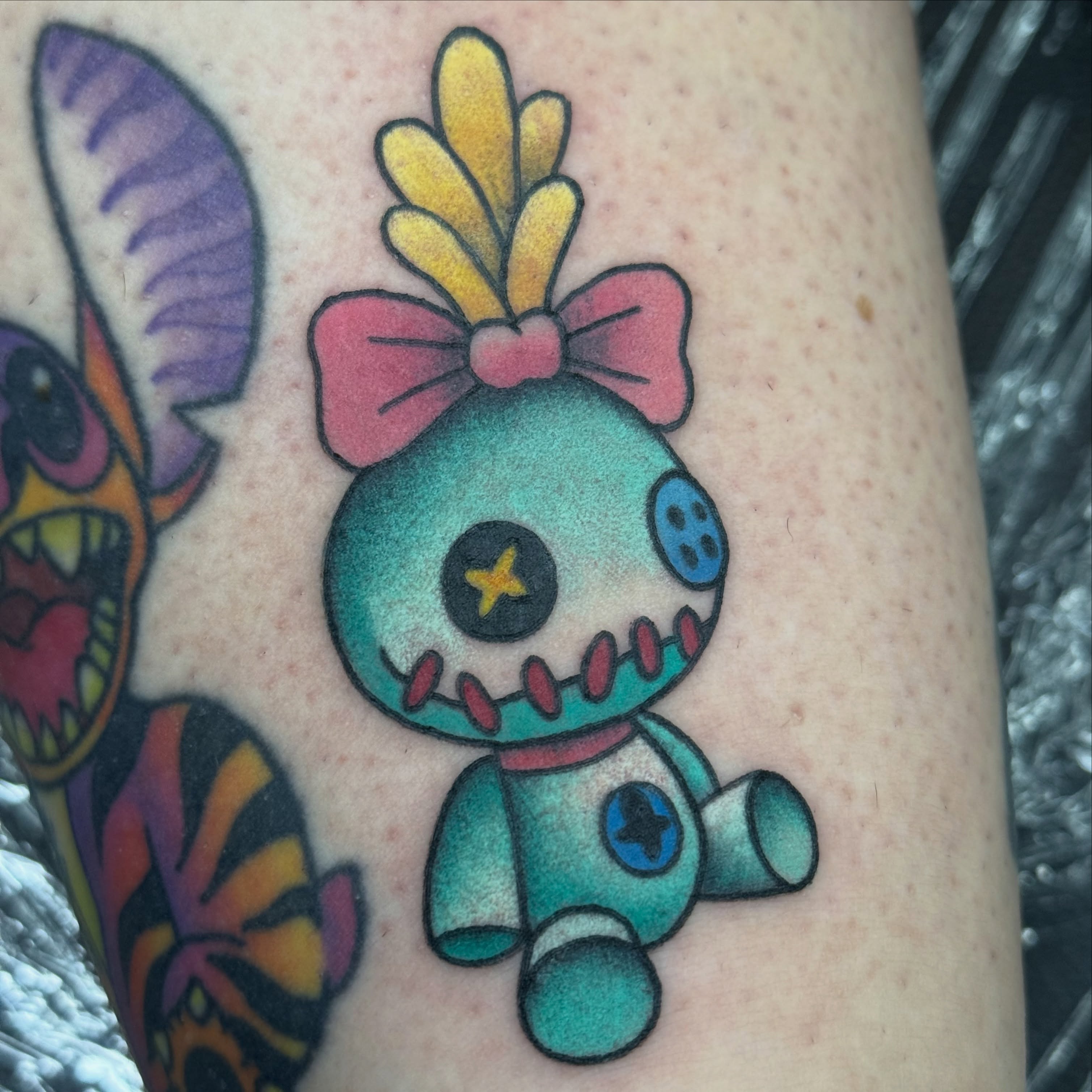 Stuffed toy American traditional tattoo on the upper arm by Kara Mosqueda