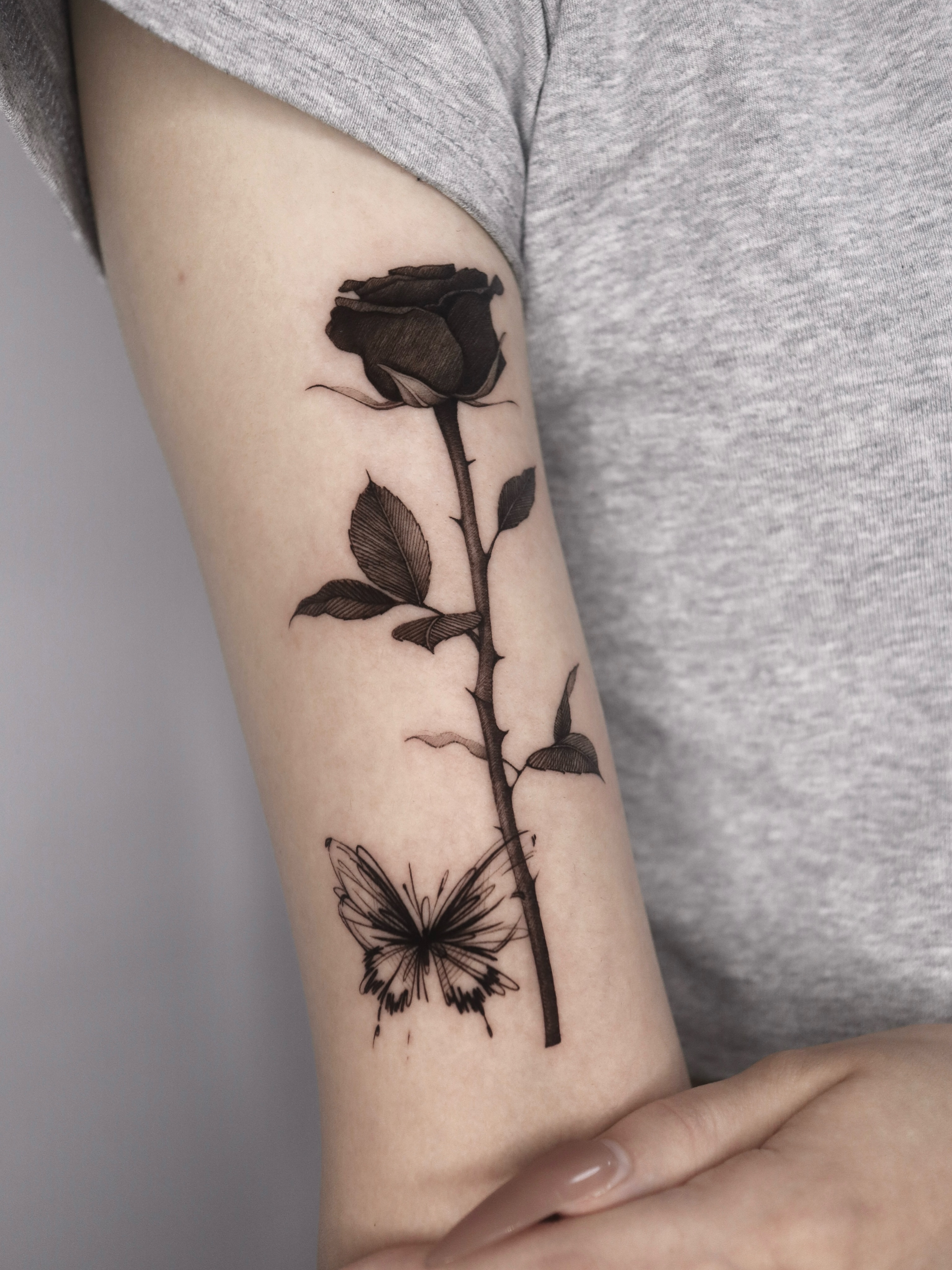 Rose and butterfly realism tattoo on the forearm by @tattoo_chamsae