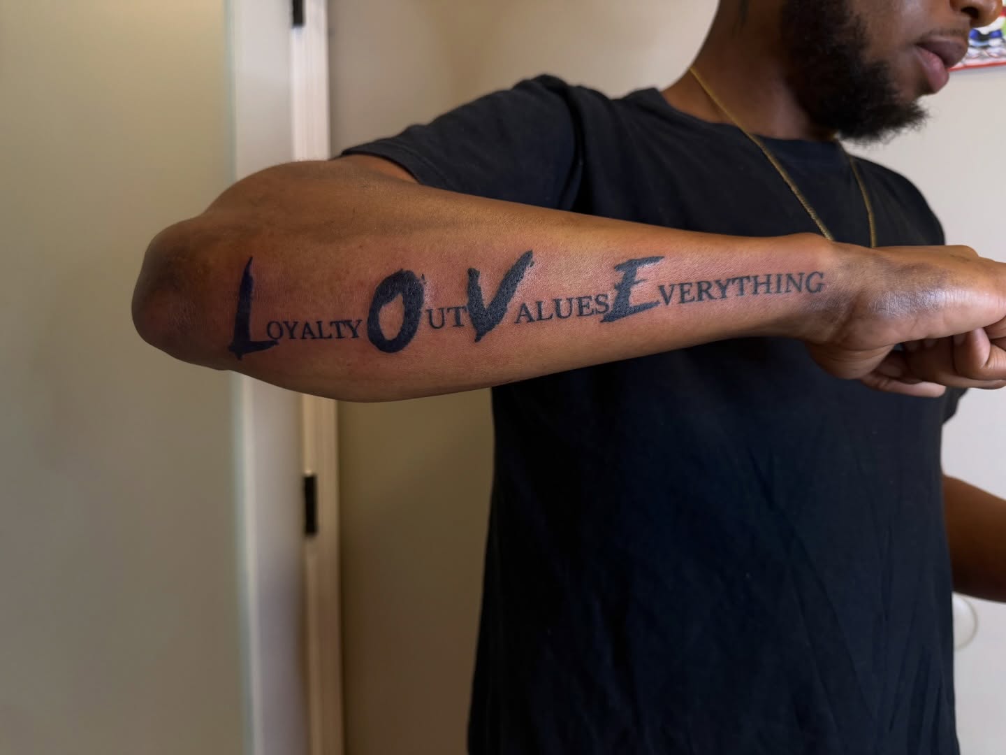 LOYALTY OUTVALUES EVERYTHING lettering script tattoo on the forearm by Room 707 Tattoo 🍰🍓