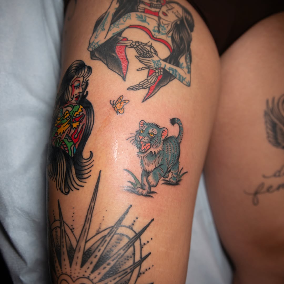 Woman with animal American traditional tattoo on the thigh by Trevor Aarsvold, Minneapolis, Minnesota